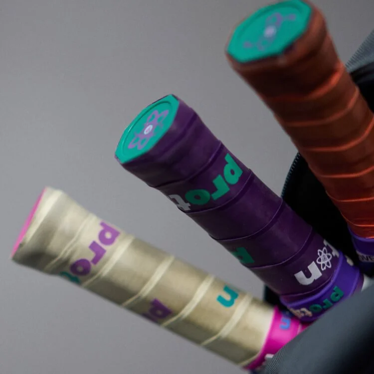 A close-up of two stacks of poker chips, one purple and one orange, with a blurred background.