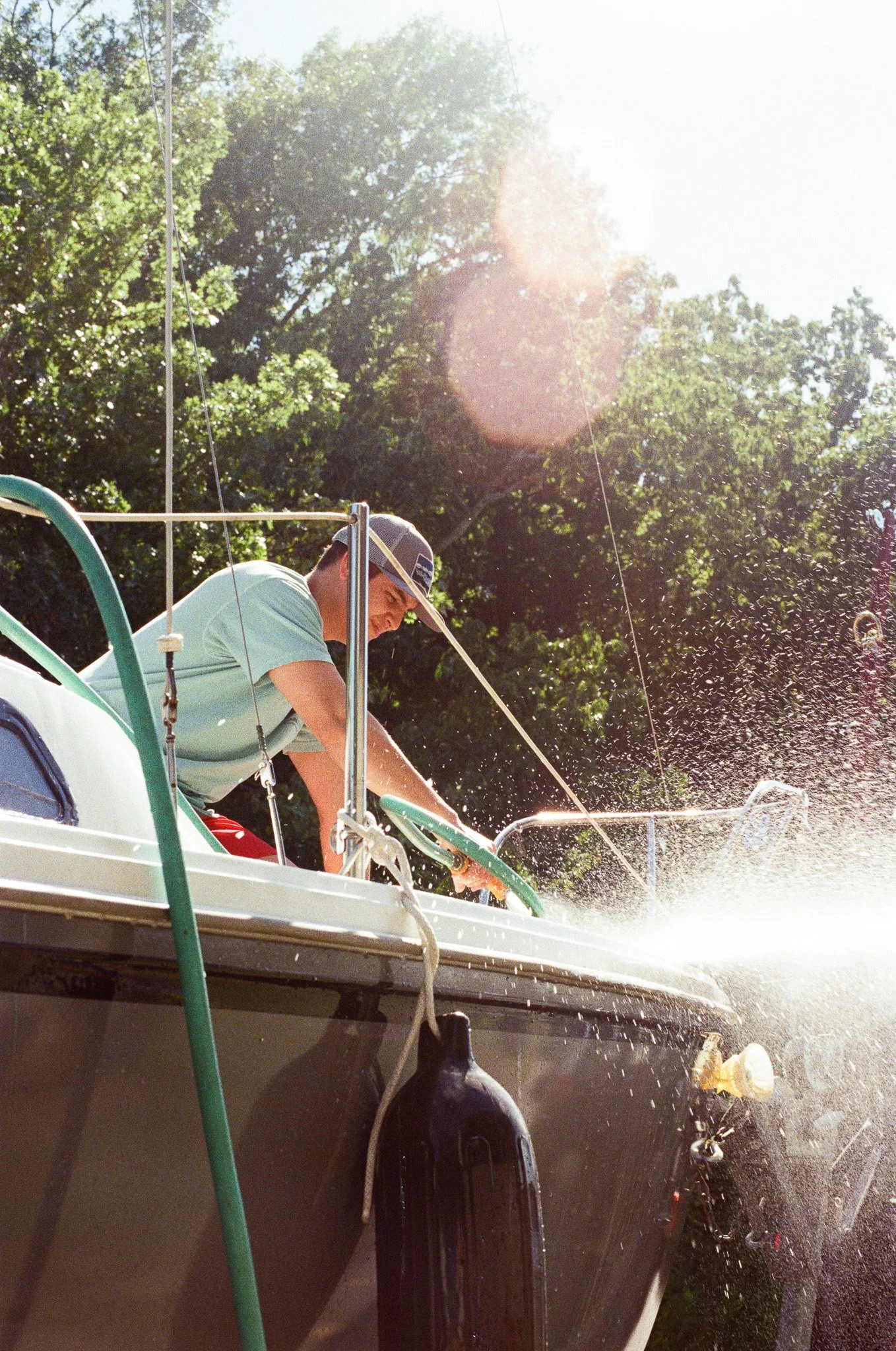 Captain sprays off sailboat in marina in Nashville, TN.