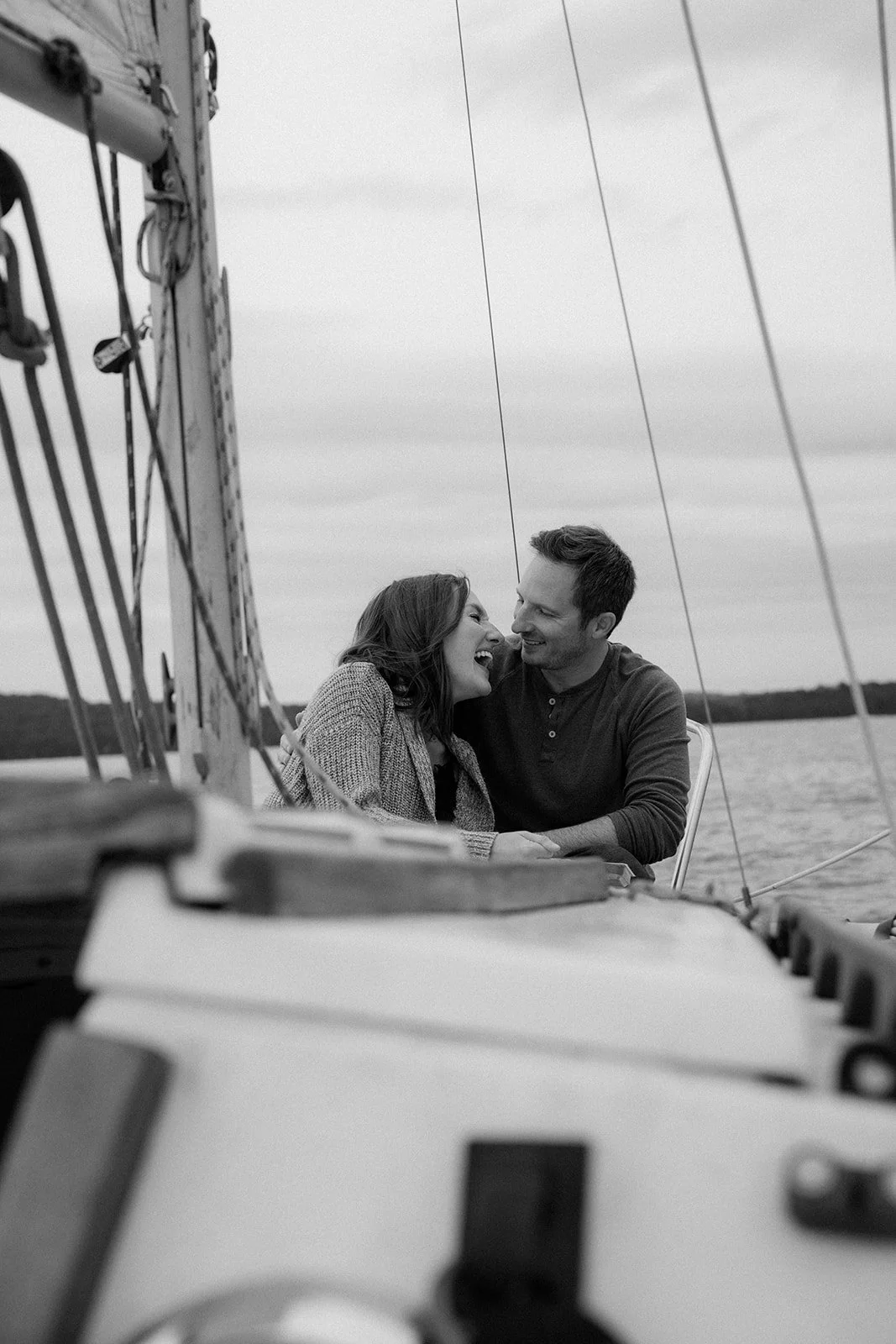 Couple laughs candidly together while sailing on Percy Priest Lake in Tennessee.