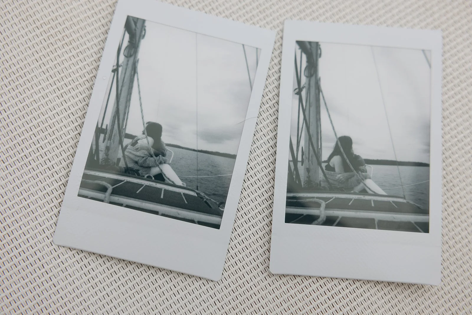 Candid photos of a couple snuggling on a sailboat.