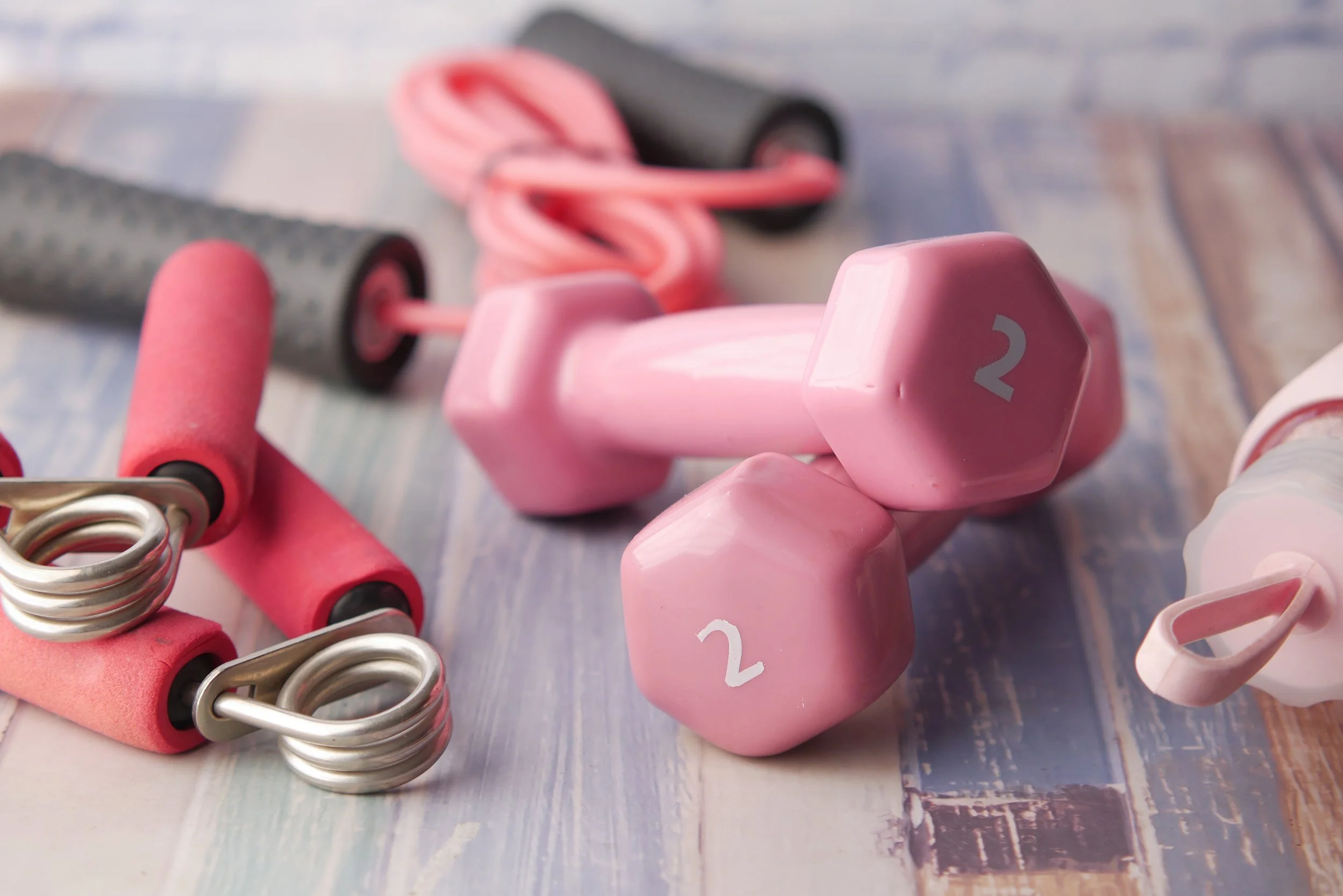 pink-color-dumbbell-shoe-and-headphone-on-pink-b-2023-11-27-05-21-27-utc.jpg