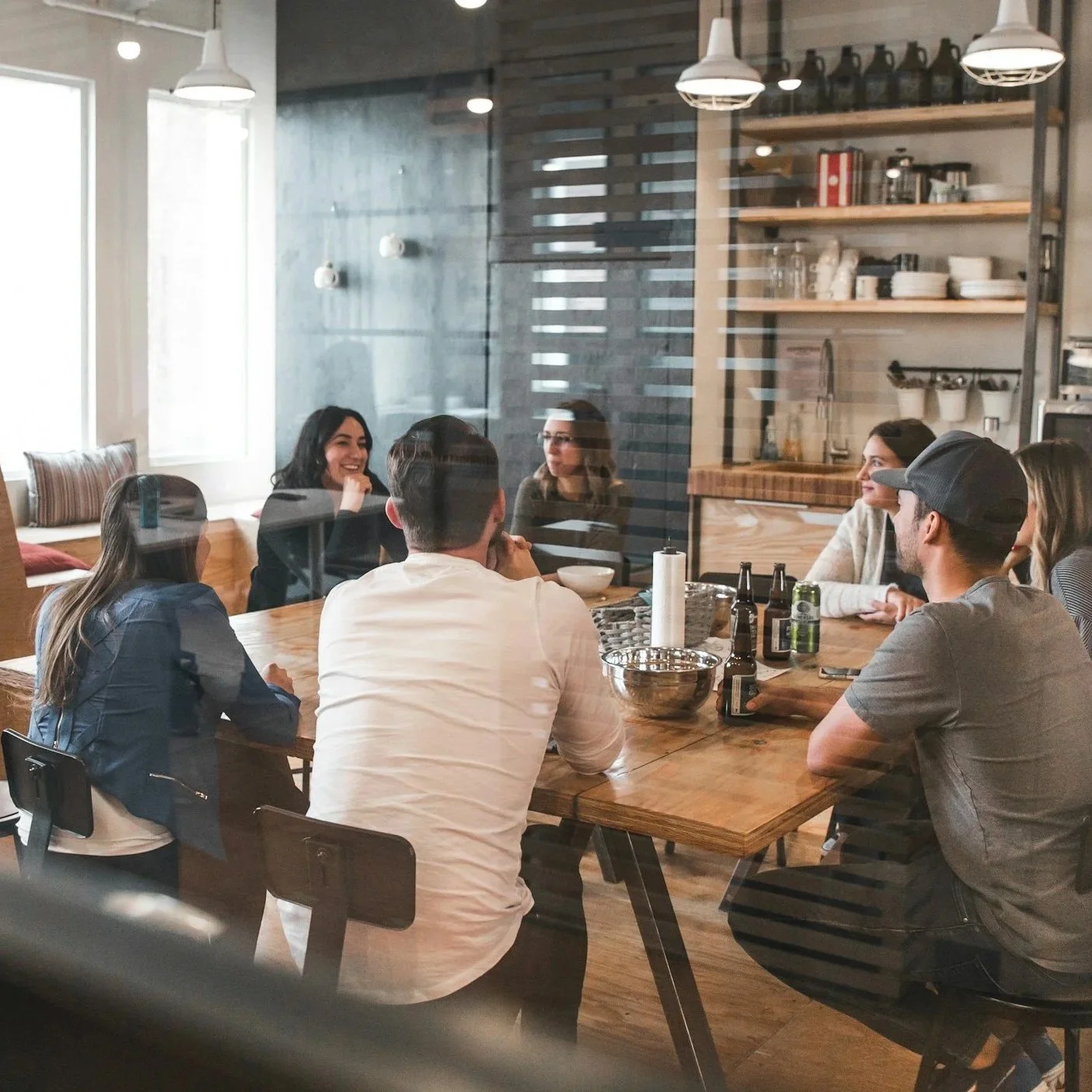 Seven people around a table in a conference room