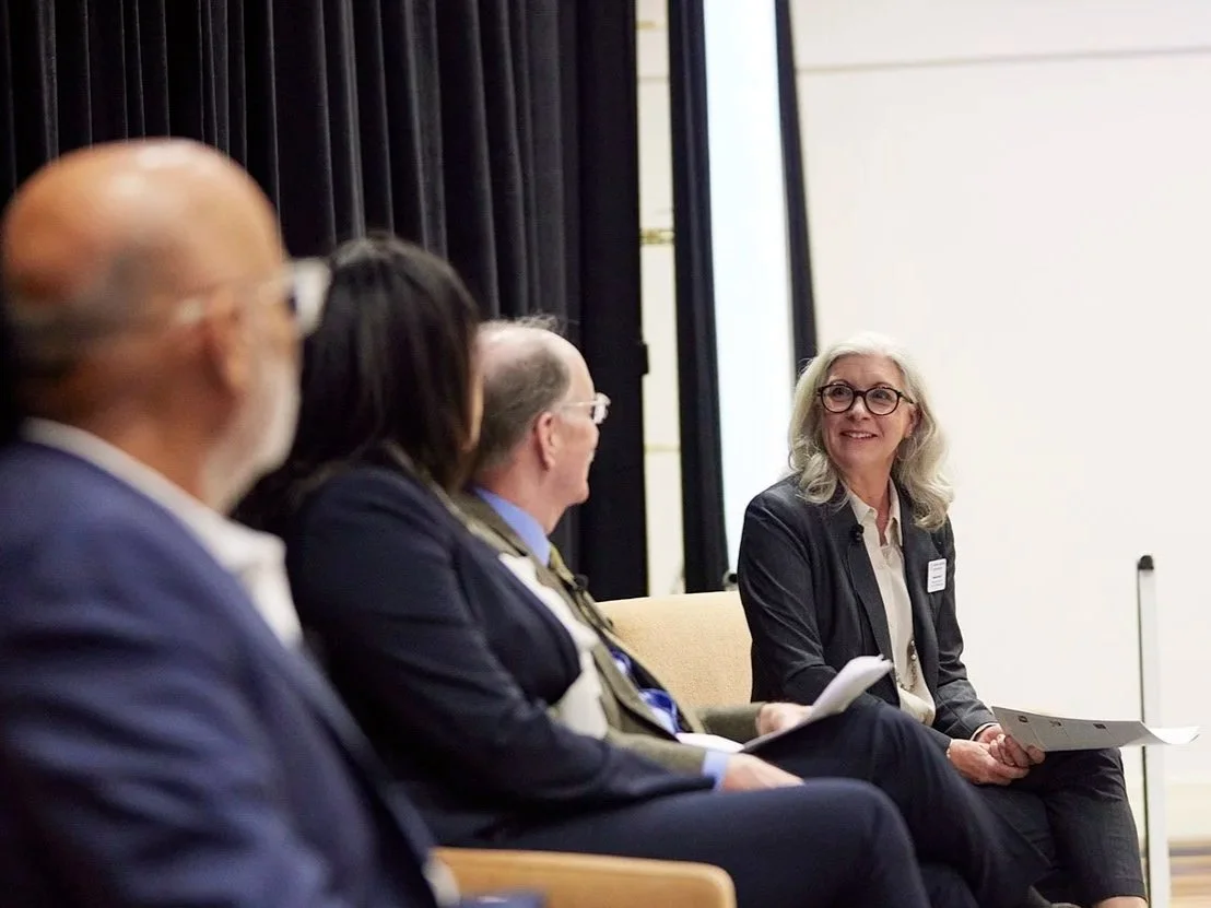 Melanie Booth moderating a panel discussion at HLC Conference