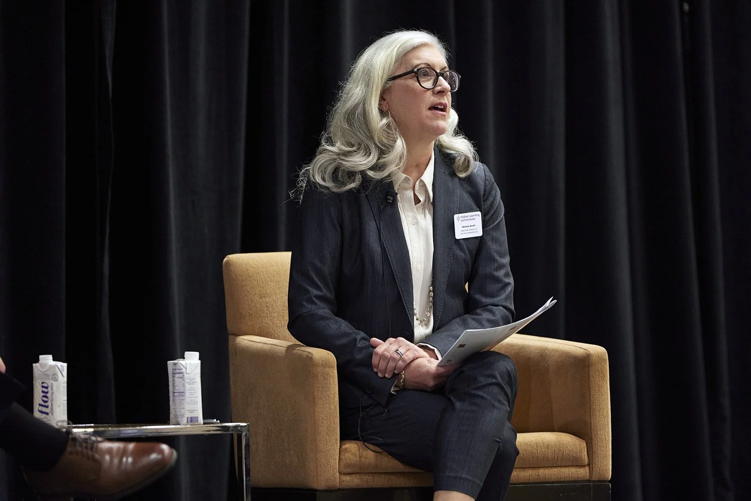 Melanie Booth moderating a panel discussion at HLC Conference