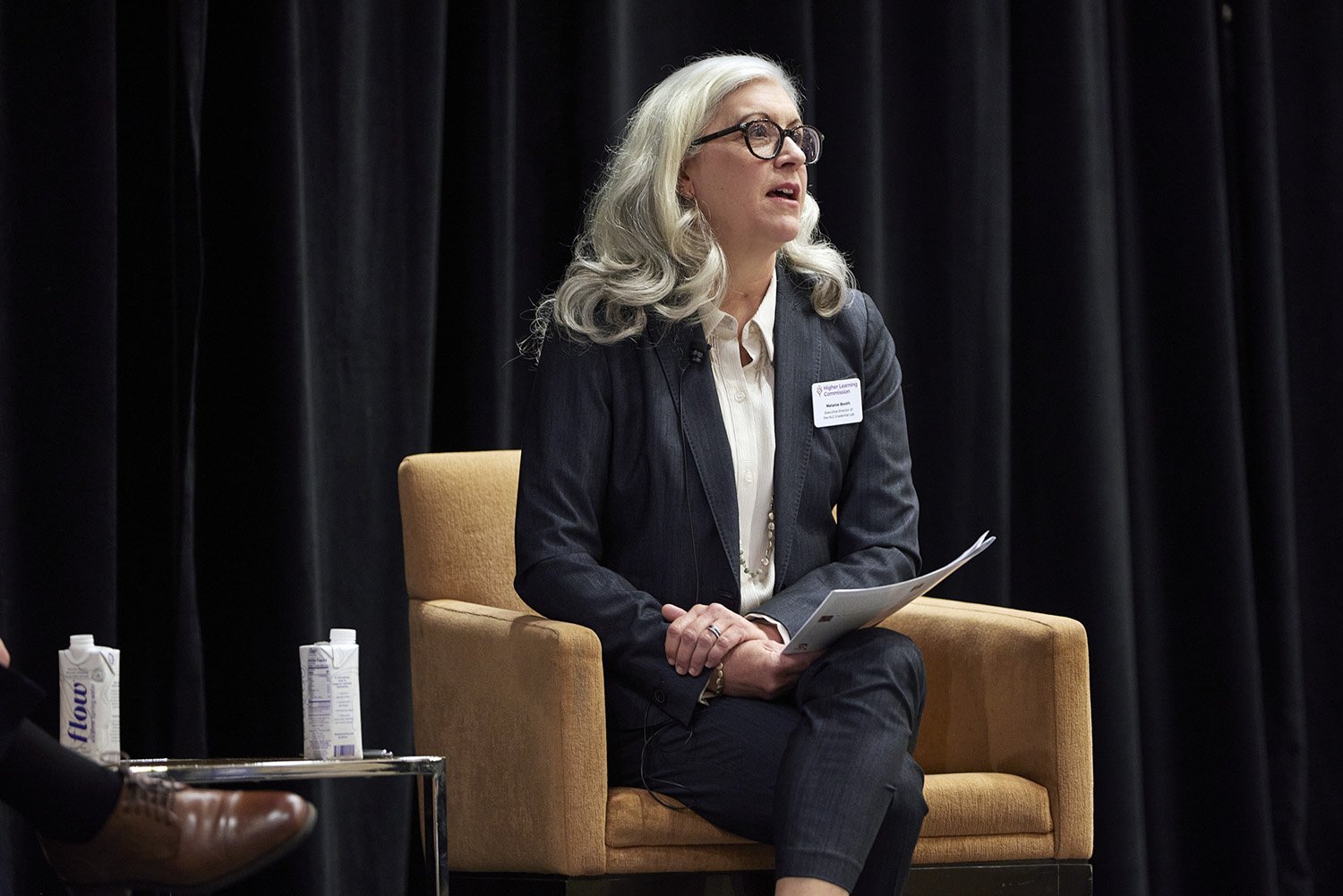 Melanie Booth moderating a panel discussion at HLC Conference