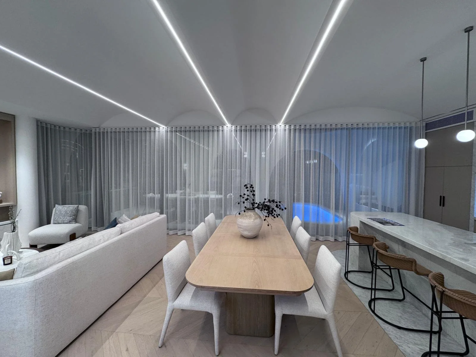 Modern living room and dining area with white sofa, chairs, wooden table, and sheer curtains in a stylish interior.