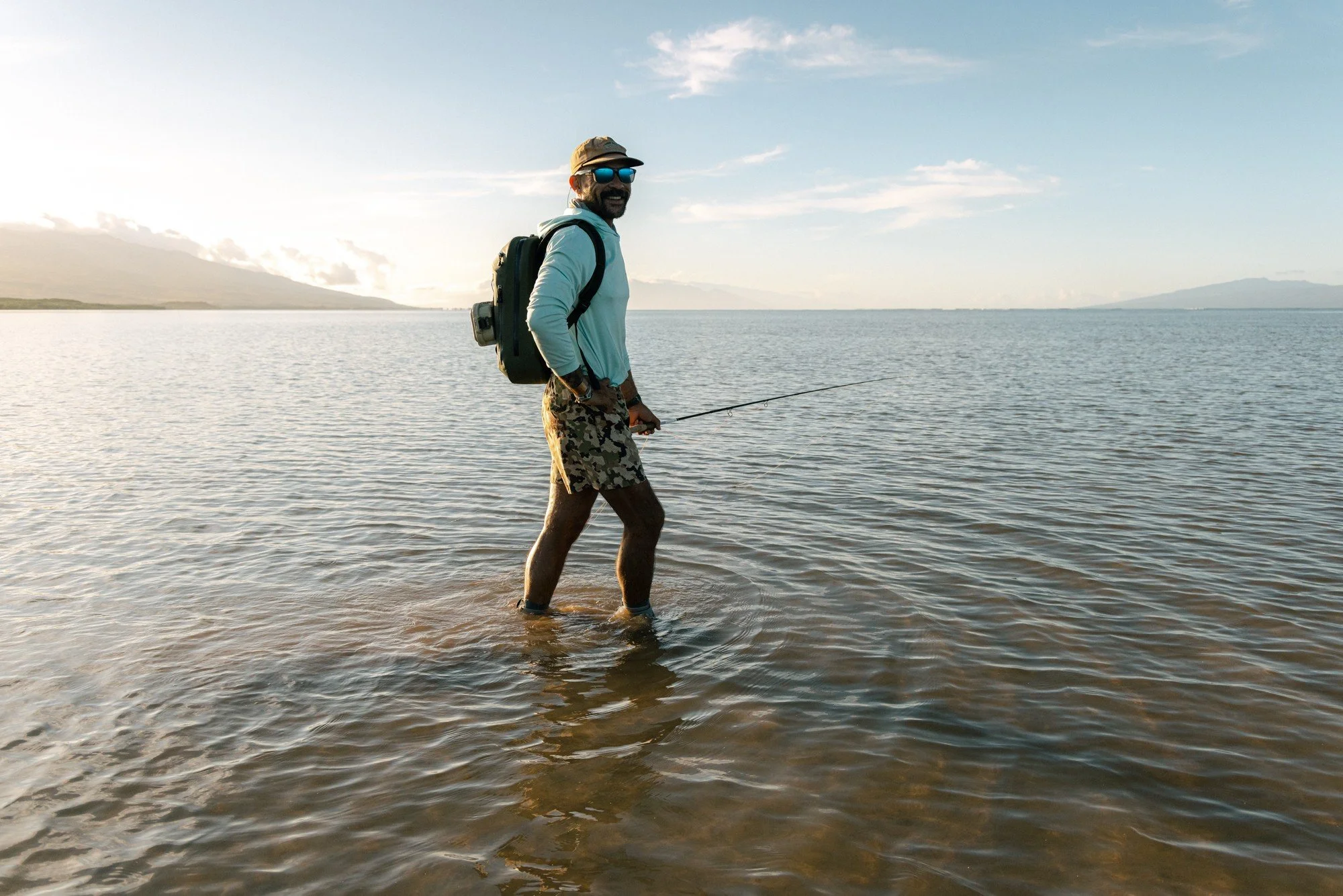 Josiah Ching wading the Molokai flats with a fly rod at dawn