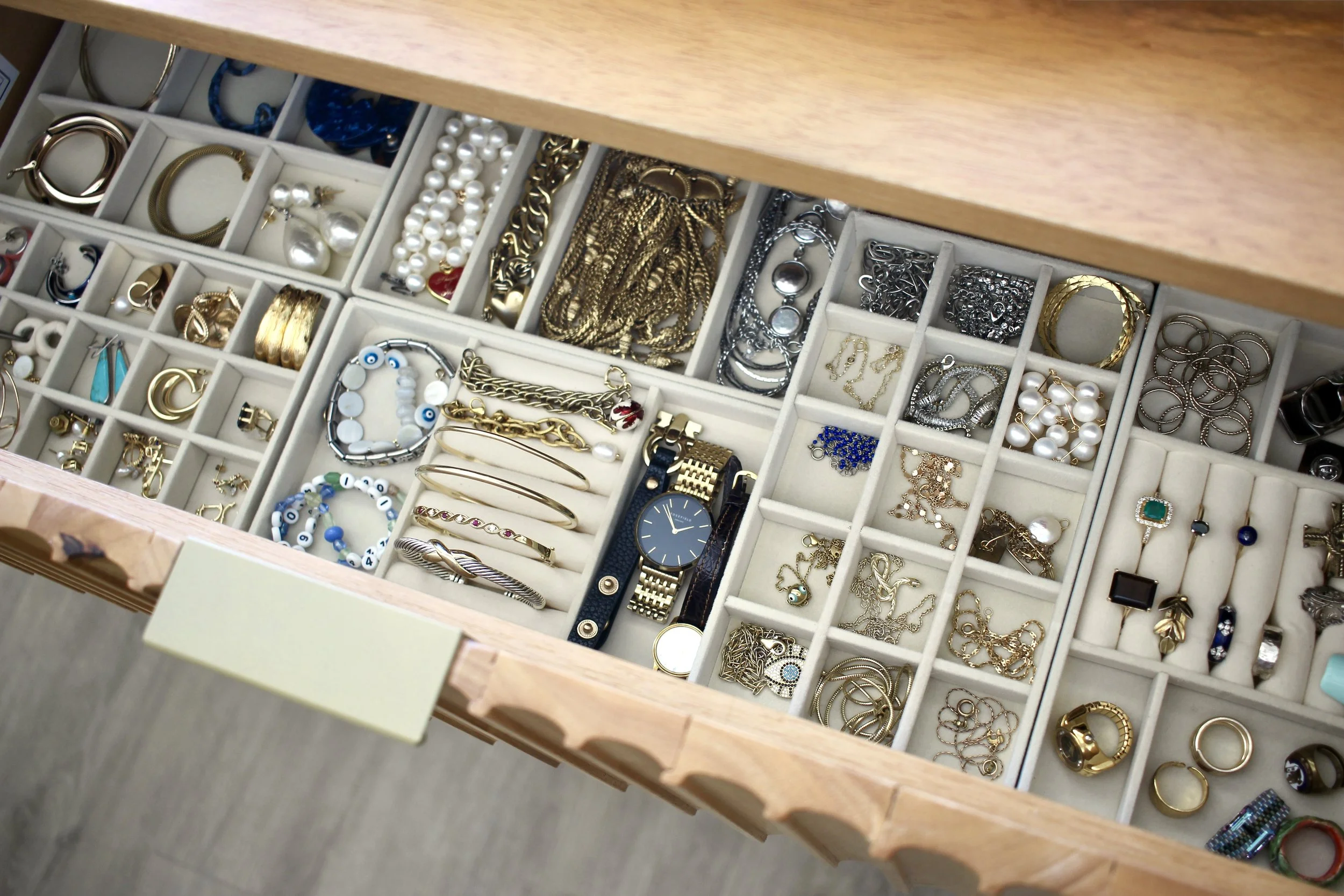 A drawer of organized jewelry