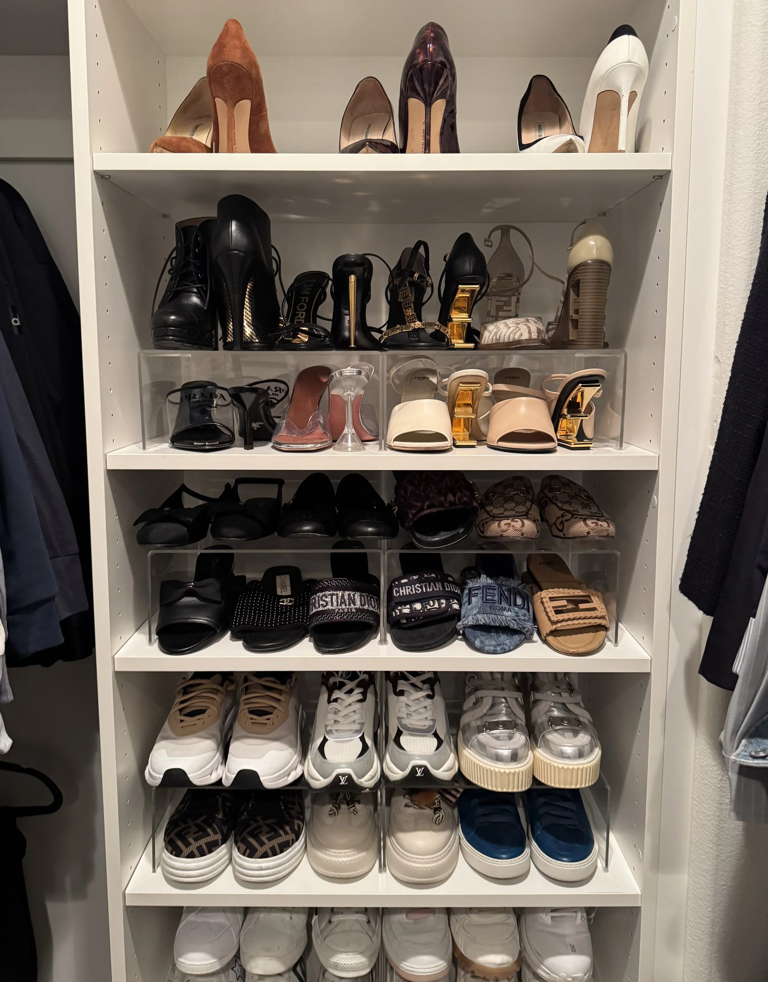 A wall of shelves with organized shoes
