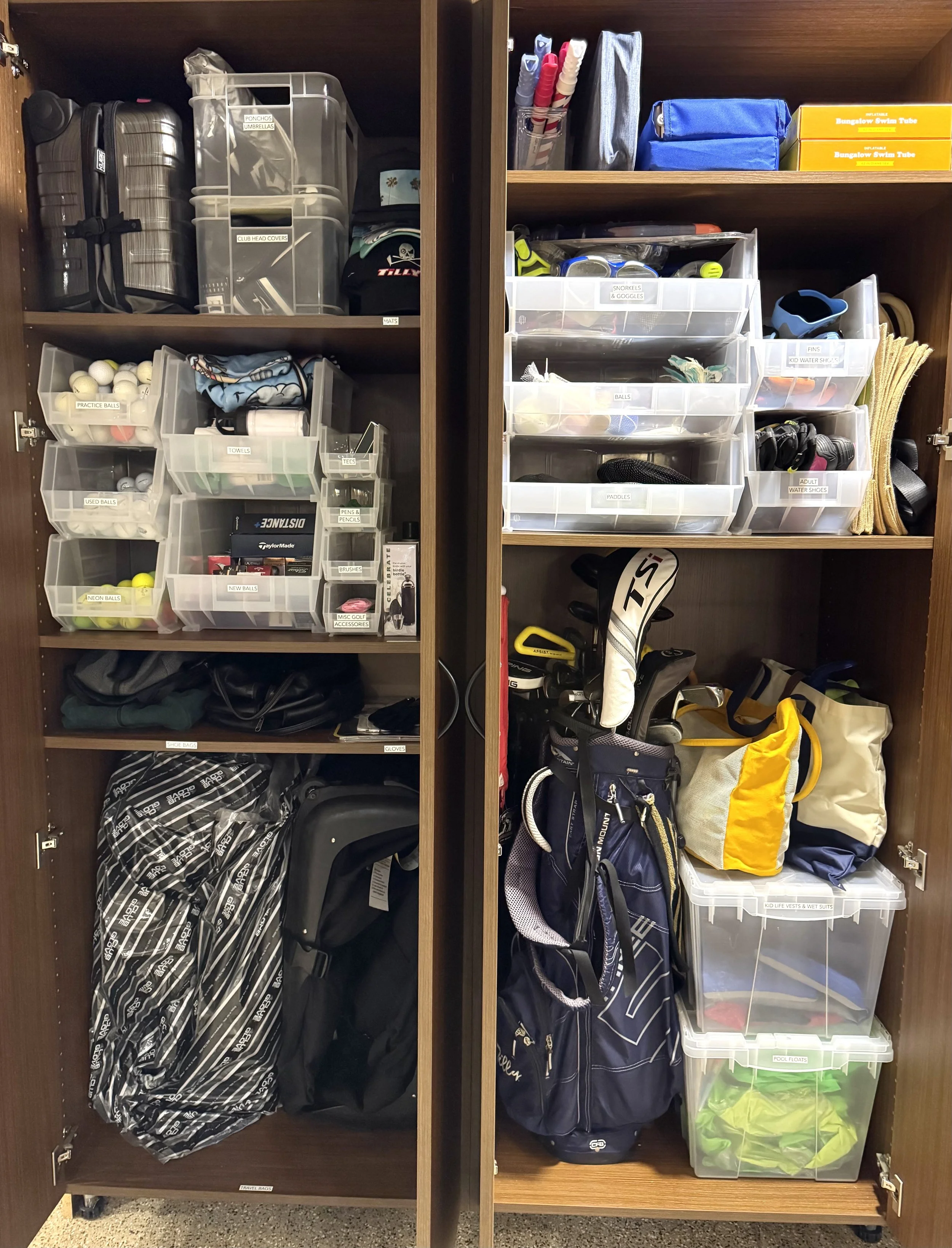A garage cabinet with golf and summer equipment