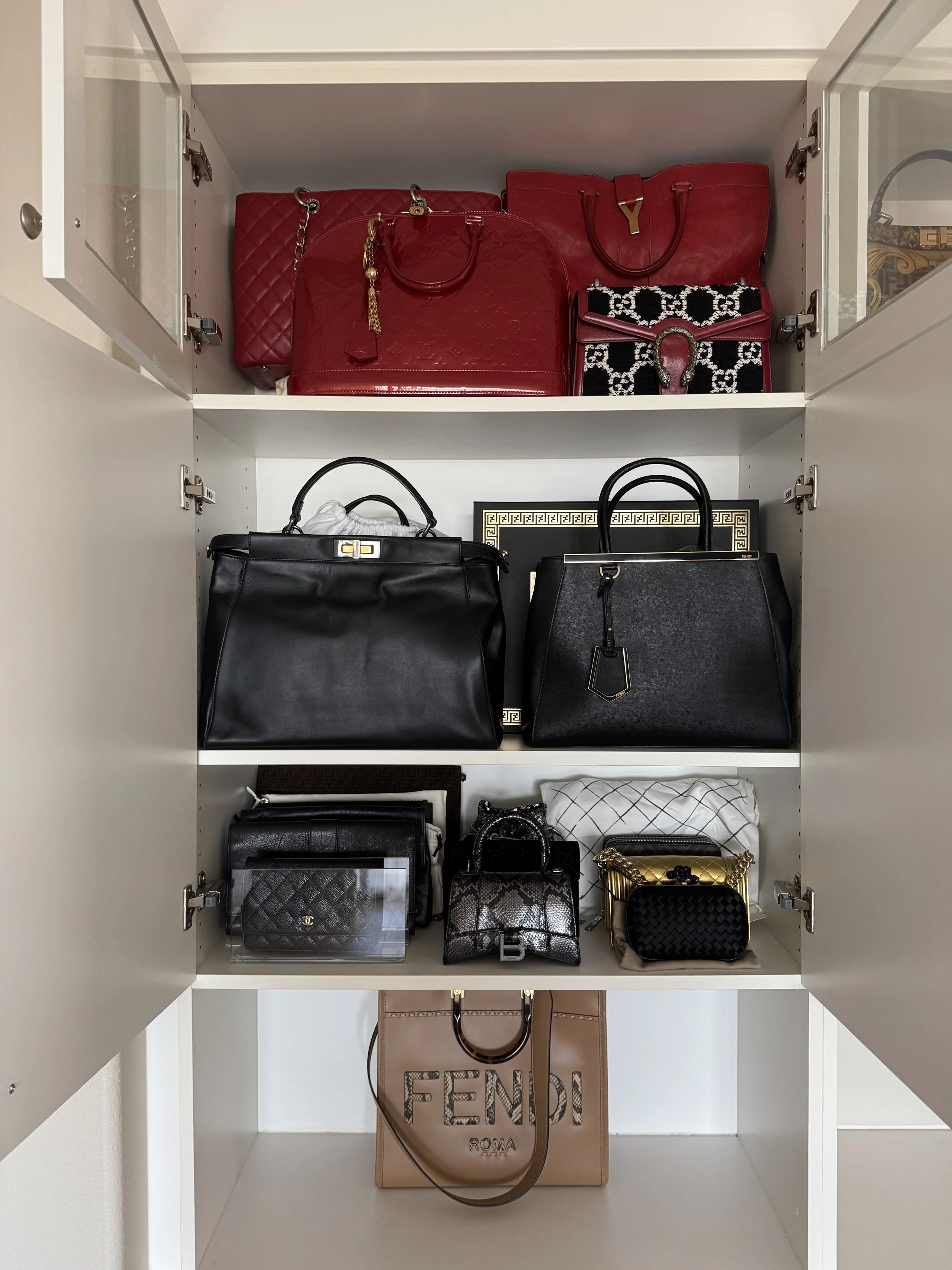 A cabinet of purses on display