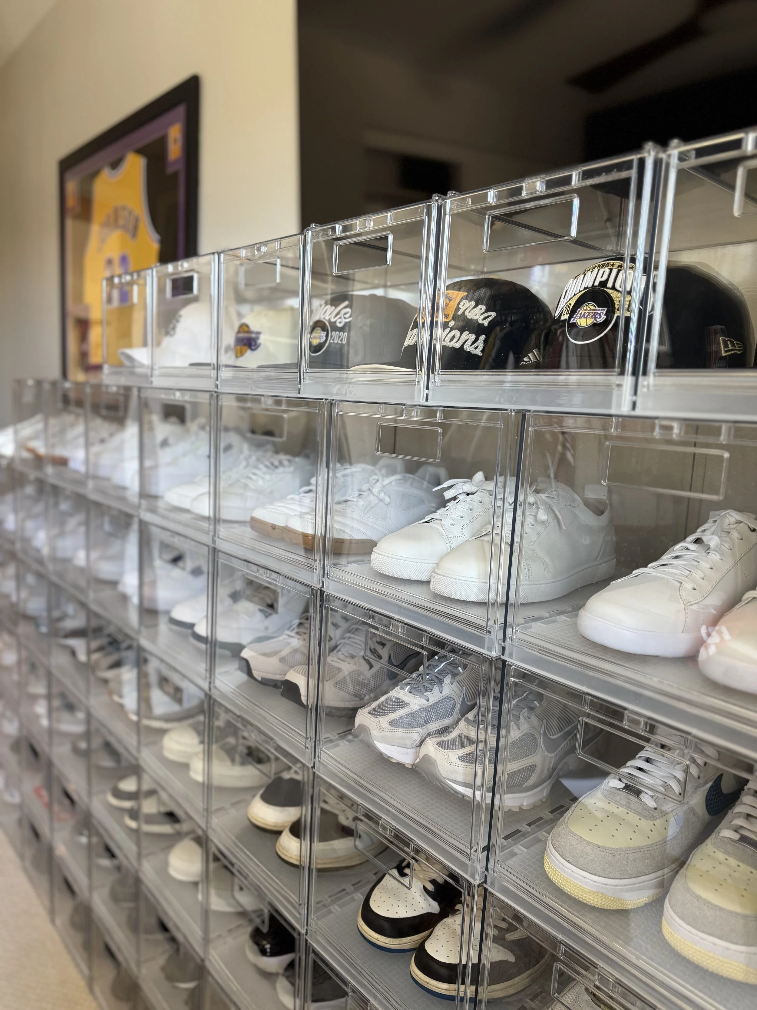 collectable sneakers stacked in protective display cases