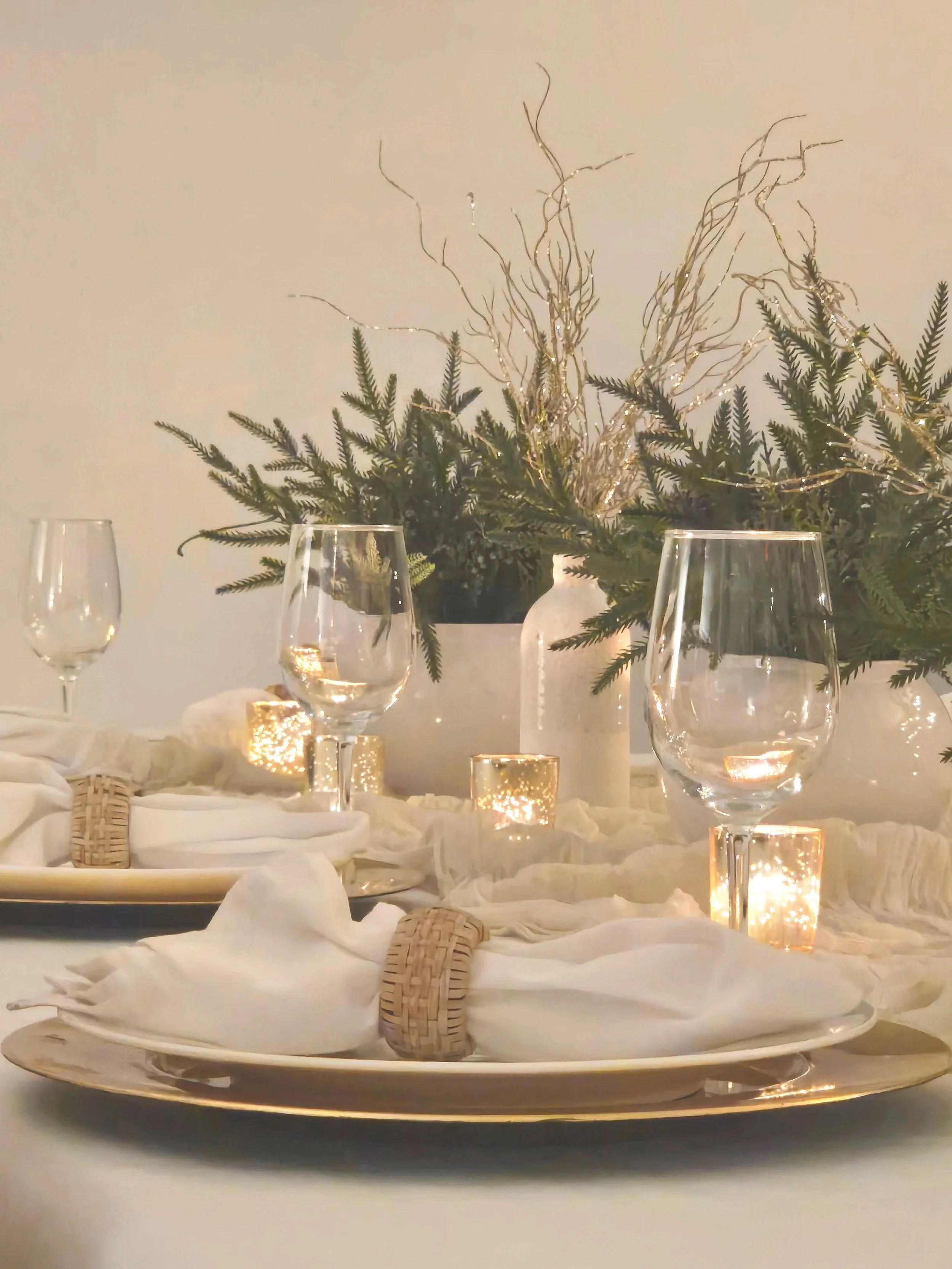 Christmas table-scape  with gold charger and greens at Oasis Collective in Sarasota, FL