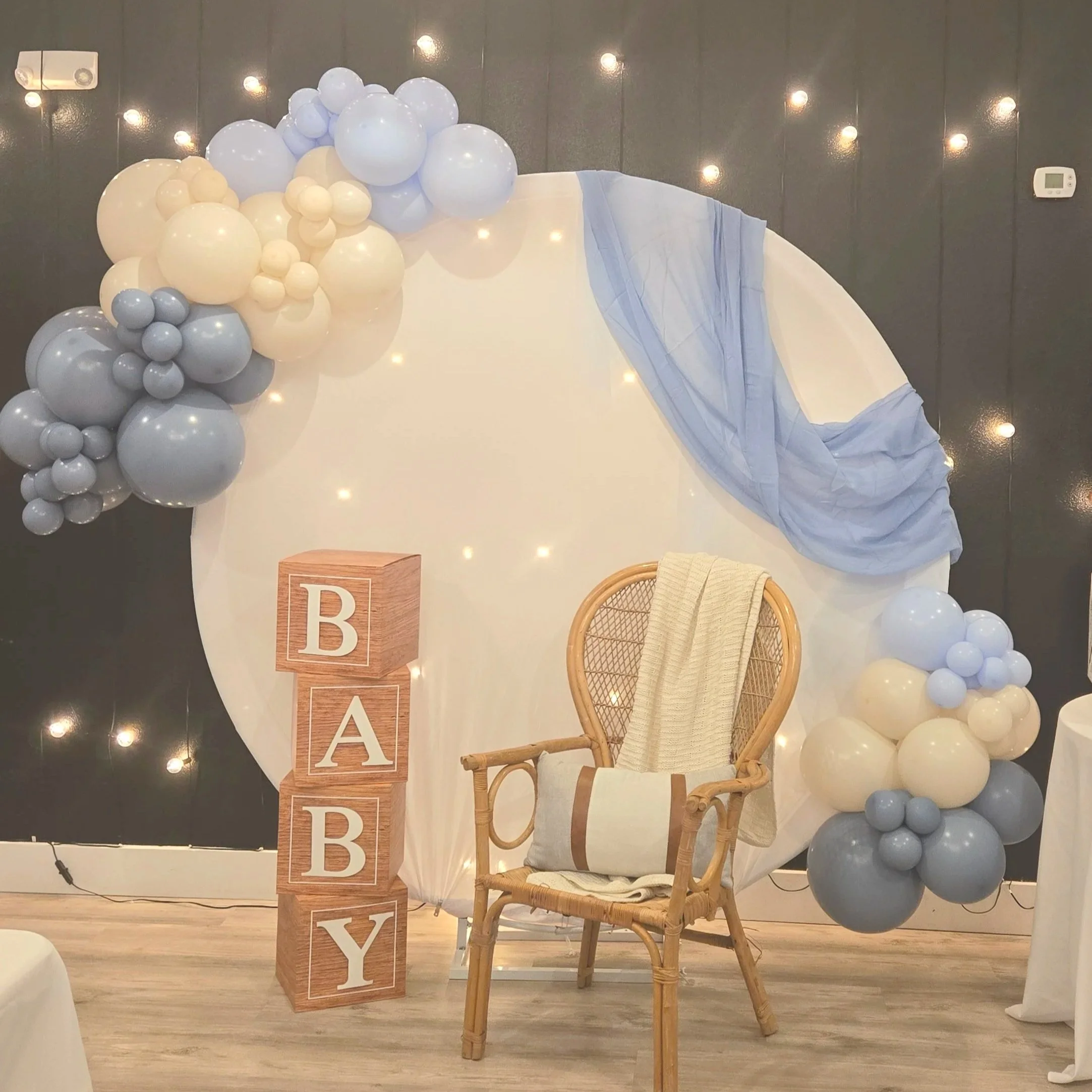 Balloon arch with BABY blocks and wicker chair for baby shower at Oasis Collective in Sarasota, FL