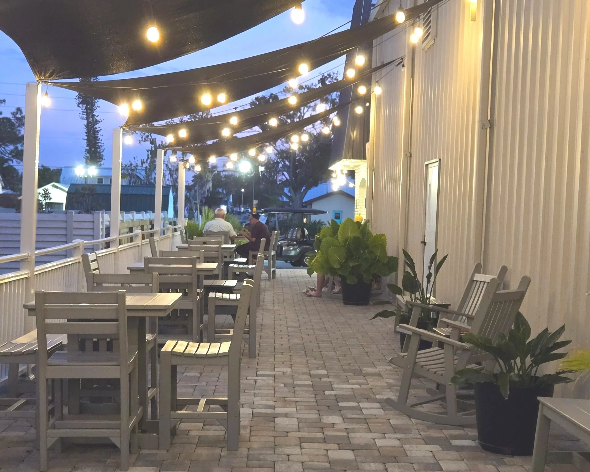Outdoor patio at Oasis Events Collective in Sarasota Florida.  Shared space with Scoops and Sprinkles Creamery. Venue for baby showers, bridal showers, gender reveals, grad parties, business meetings