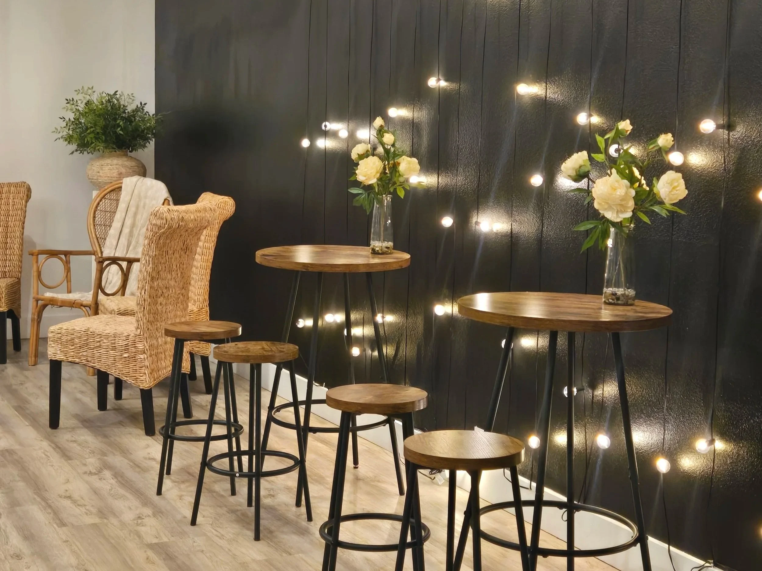 Cocktail tables and flower arrangements in venue at Oasis Events Collective in Sarasota FL.  Events space for bridal showers, baby showers, birthday parties, worship nights and end of life celebrations near Myakka City, Lakewood Ranch, and Parrish.