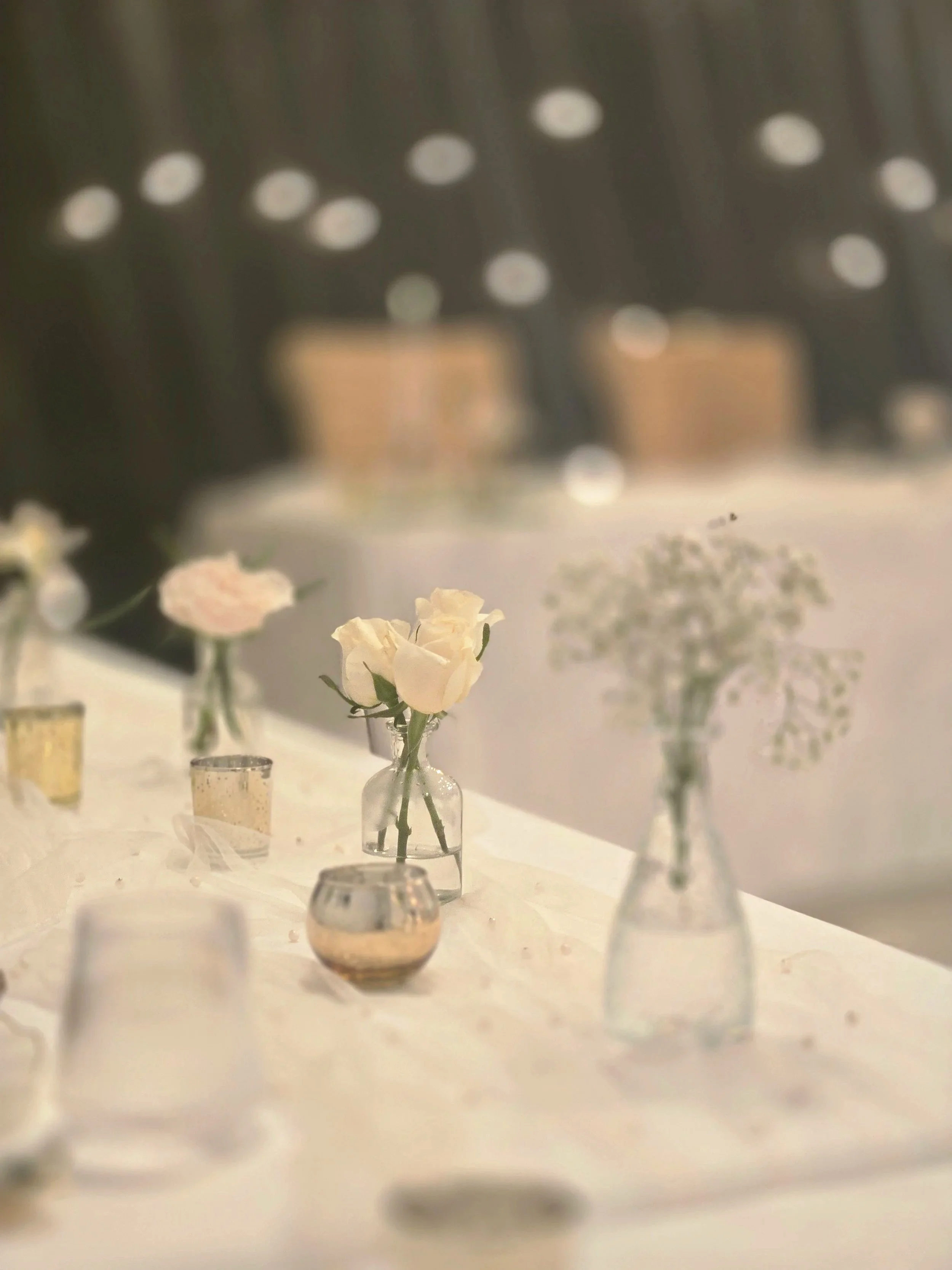 Budvases and flowers at a rehearsal dinner at the cozy Oasis Events Collective in Sarasota FL