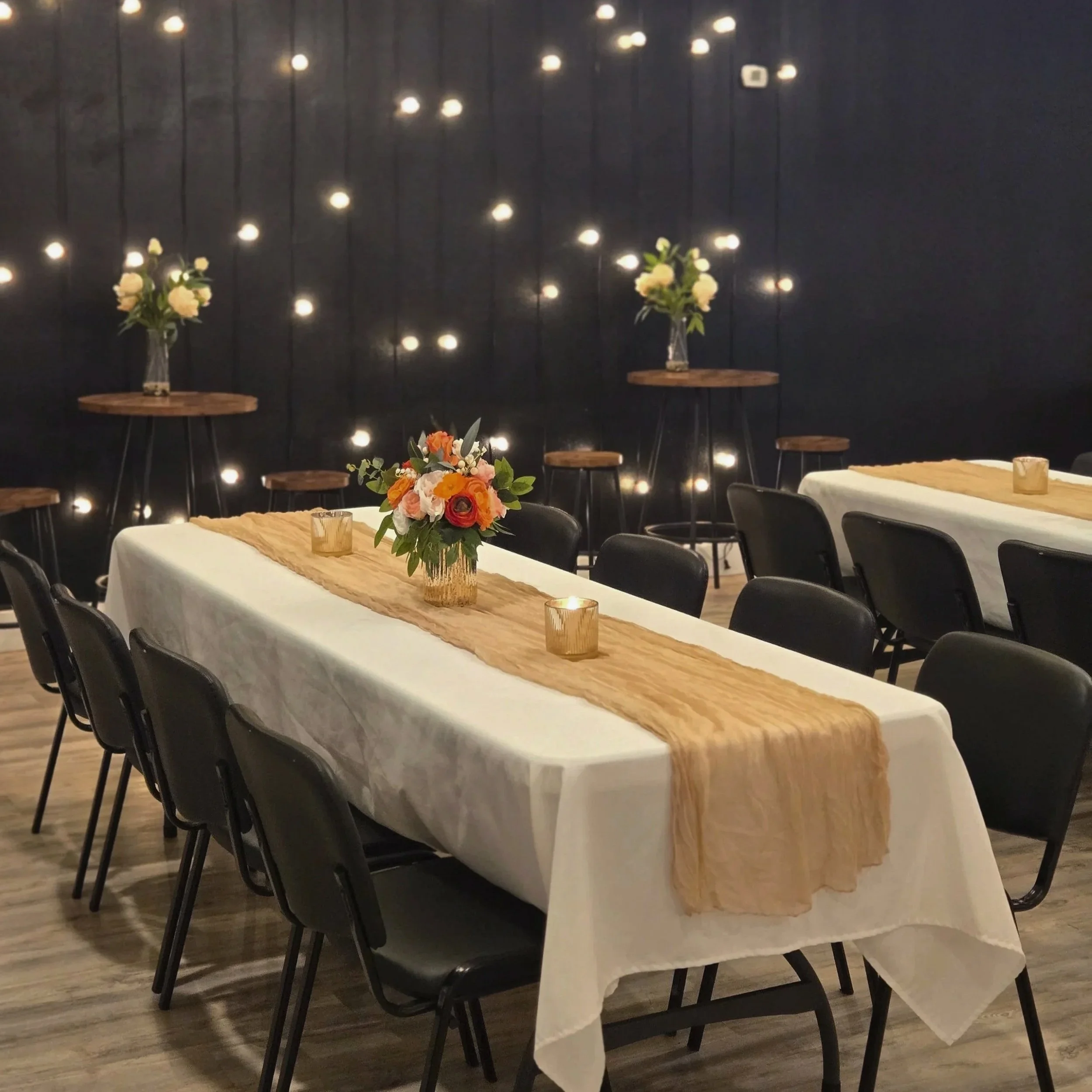 Tables and chairs that are included in your rental price at Oasis Events in Sarasota, FL.  white tablecloths with champagne table runners provide a cozy ambience.