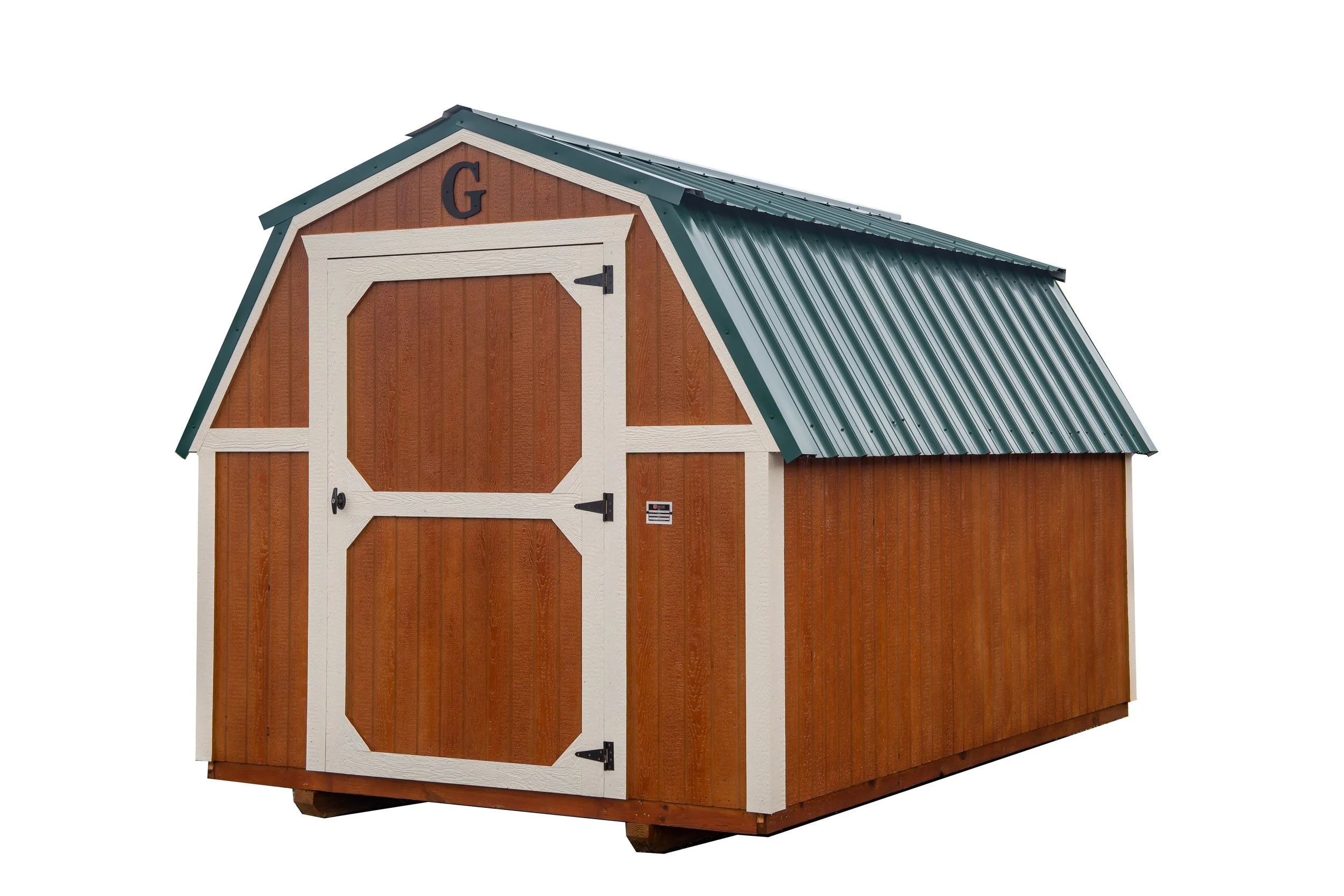 A small wooden shed with a gabled metal roof, painted in brown with white trim, labeled with a letter 'G' on top.
