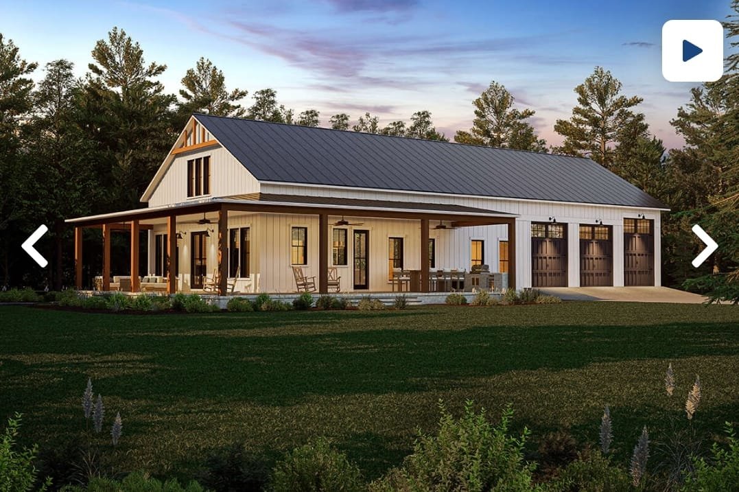 A modern two-story house with a metal roof, white vertical siding, and a large back porch with wooden beams and outdoor furniture, surrounded by a lush green yard and tall trees.