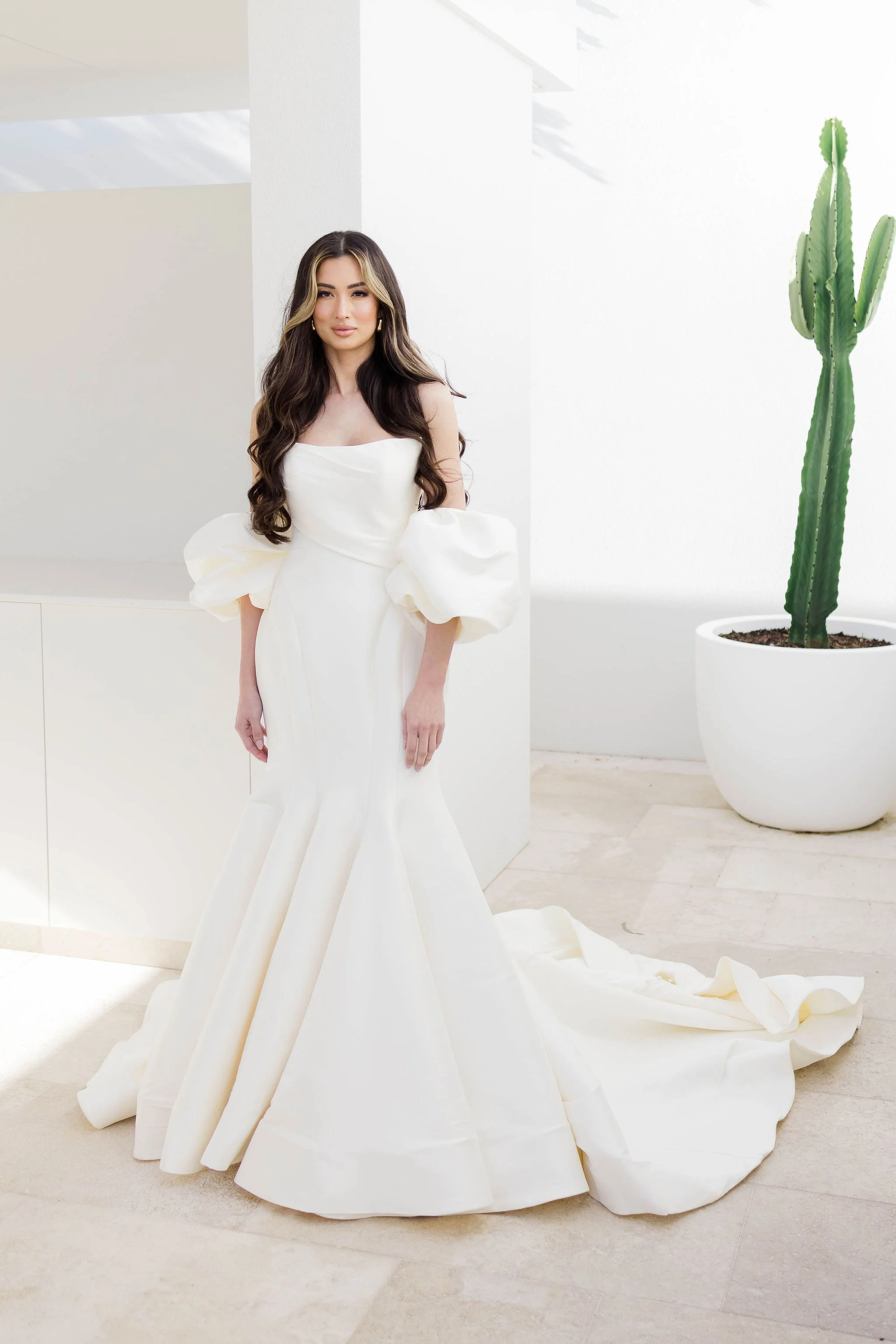 Woman in a white wedding dress with unique beautiful trendy sleeves