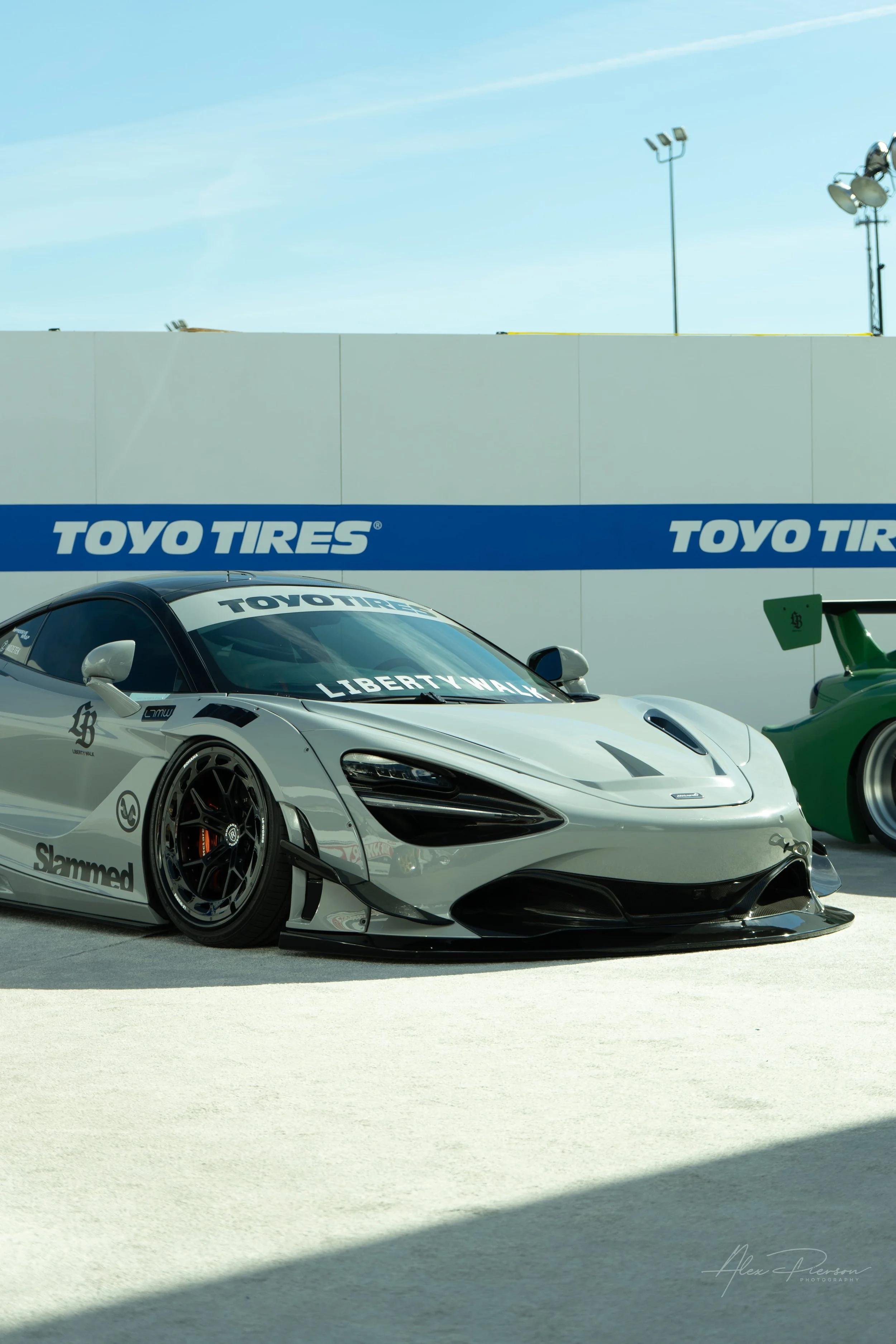 A slammed, nardo grey Liberty Walk McLaren 720S widebody supercar parked at SEMA in Las Vegas.
 Supercar perfection slammed to the ground. This sleek, nardo grey McLaren 720S features a full Liberty Walk widebody kit, sitting perfectly flush on the L