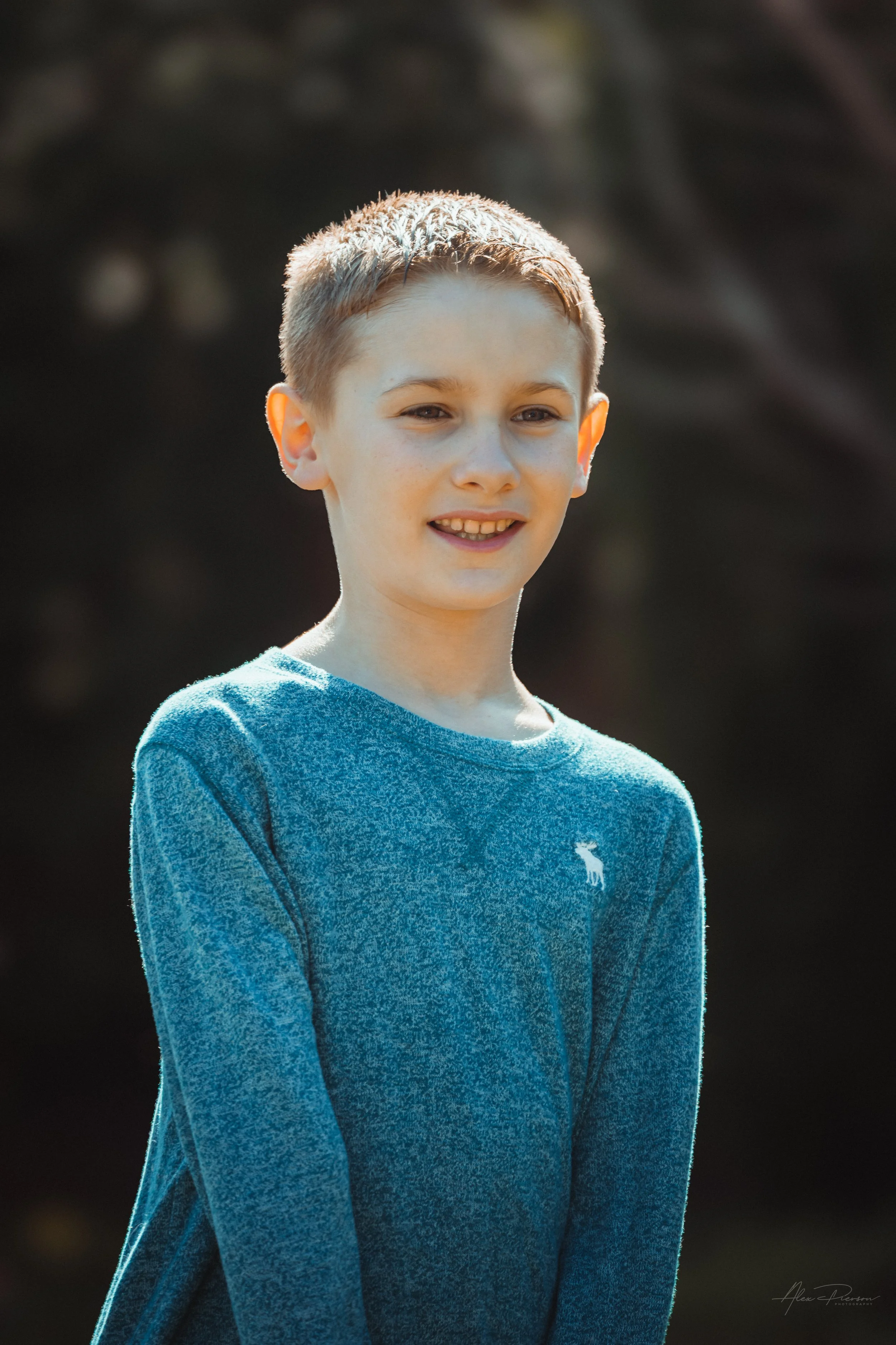 Warm natural light  portrait of a young boy  up close smiling outdoors during a portrait family photoshoot in Tumwater, WA – Pacific Northwest lifestyle family and children's photography.