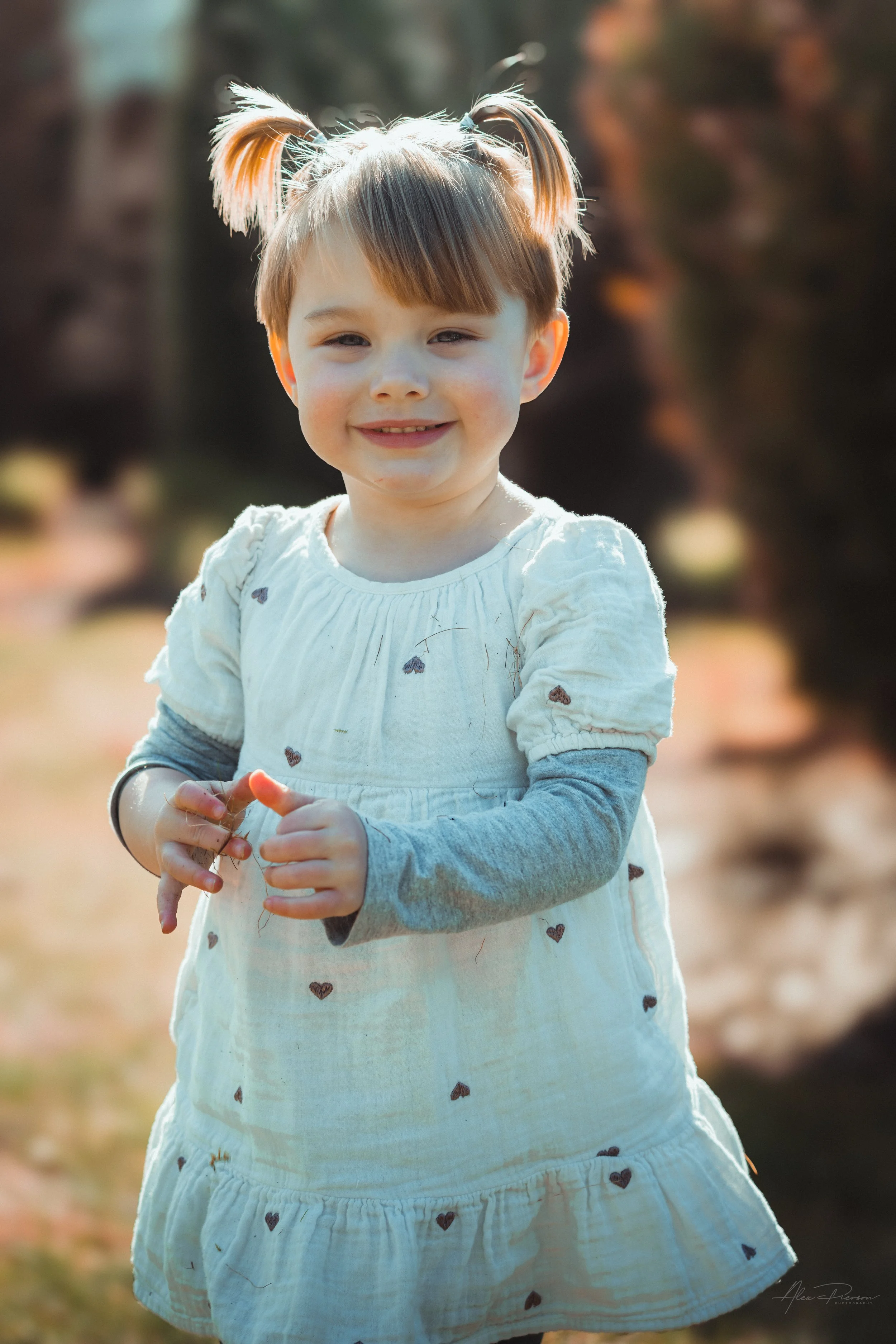 Little girl smiling and walking during a lifestyle shoot in Tumwater, WA– Pacific Northwest lifestyle family and children's photography.