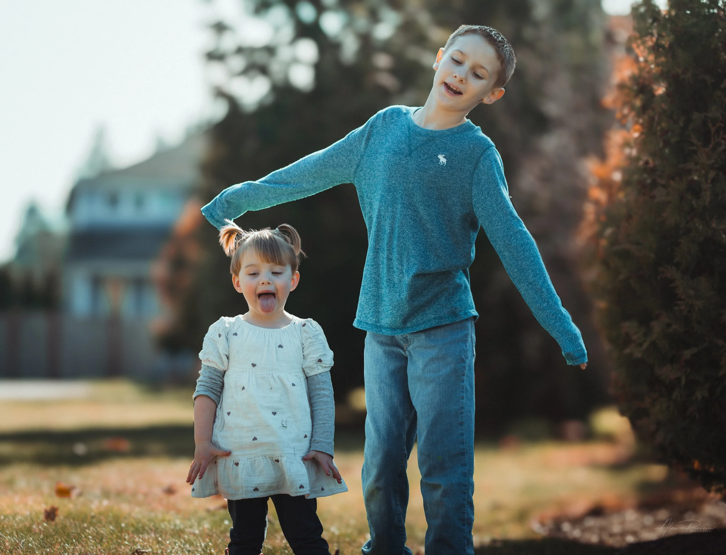  Little girl playfully making silly faces with her cousin during a candid family photo session Tumwater, WA – Pacific Northwest lifestyle family and children's photography.