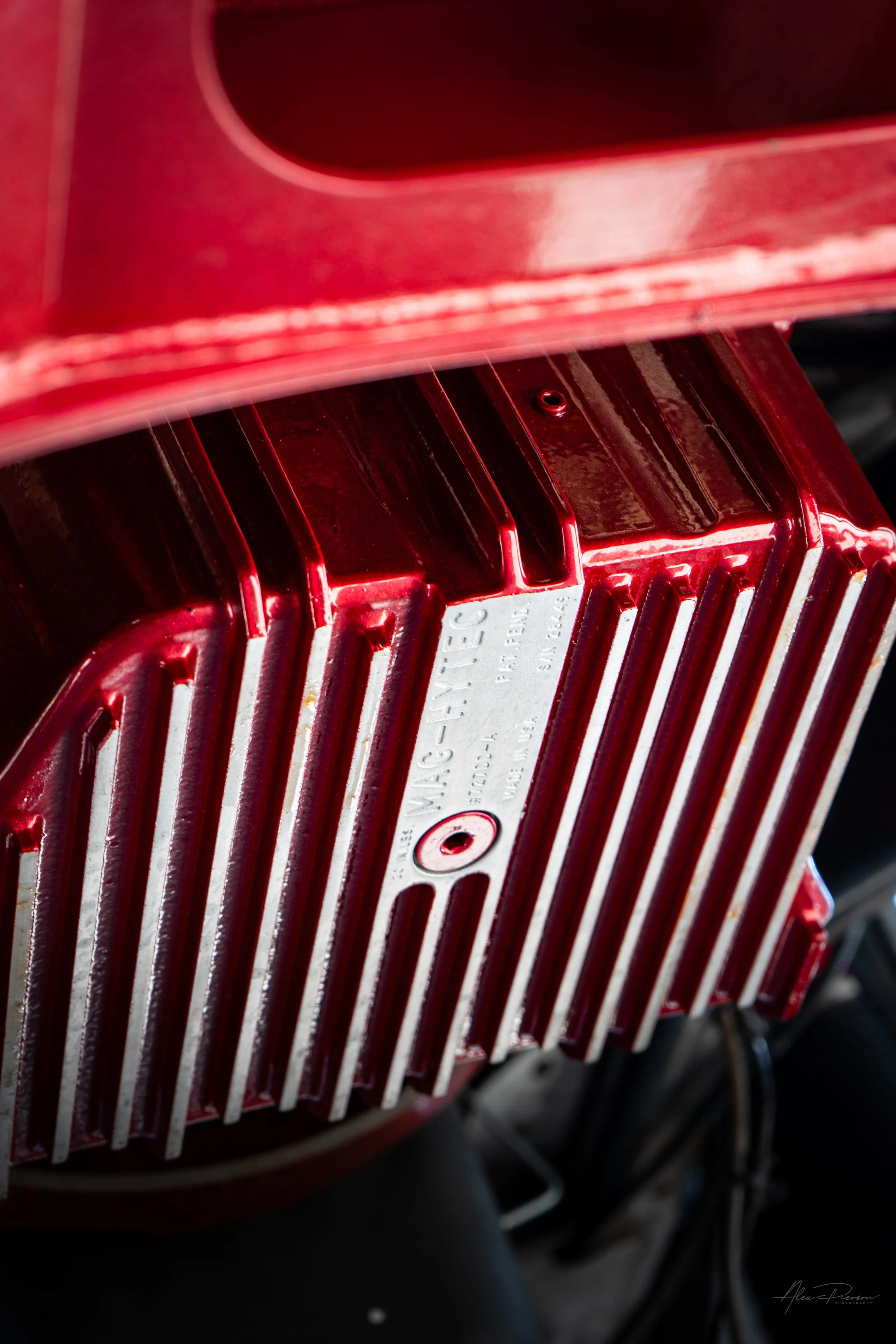Close-up view underneath a highly modified Ram 2500 featuring a custom candy red powder-coated Mag-Hytec deep transmission pan for upgraded fluid capacity.
Mag-Hytec transmission pan, red trans pan, Ram 2500 transmission upgrade, deep trans pan.
cand