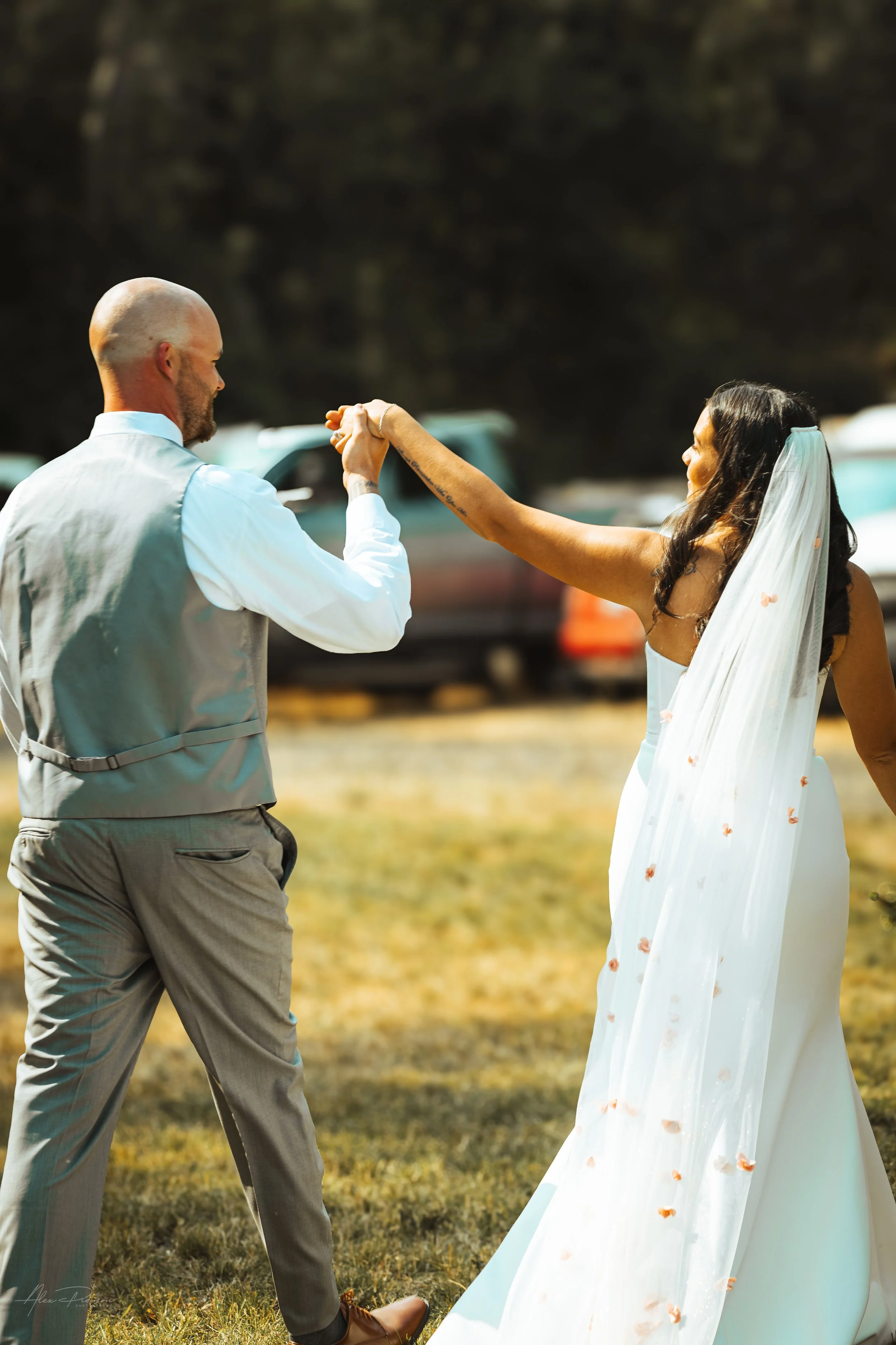 bride and groom walking away while holding hands during their wedding in Olympia, WA