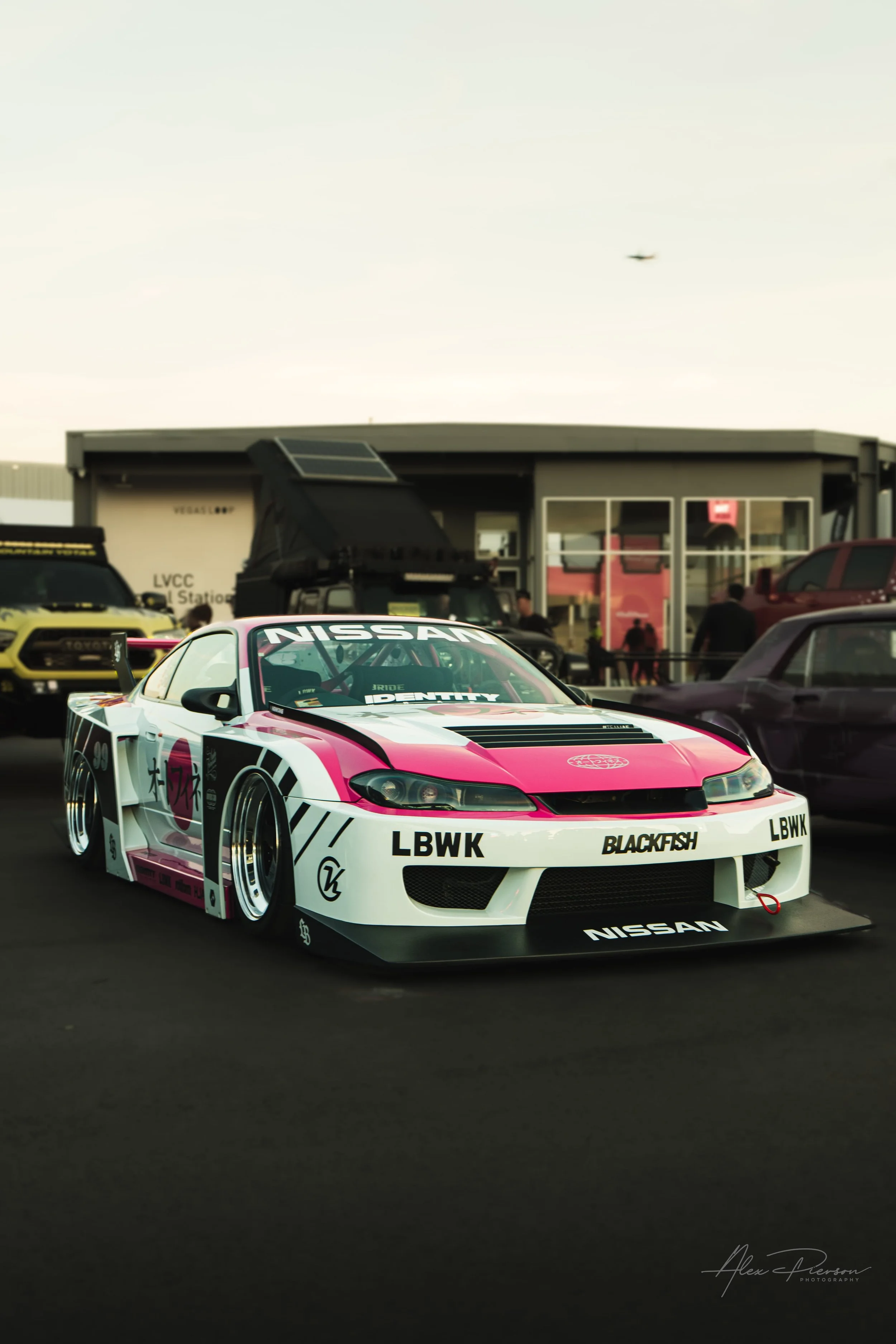 A Liberty Walk widebody Nissan Silvia S15 with a white, pink, and black racing livery at SEMA Las Vegas.
Ultimate JDM styling. A fully built Nissan Silvia S15 rocking an aggressive Liberty Walk widebody kit and a striking white, pink, and black retro