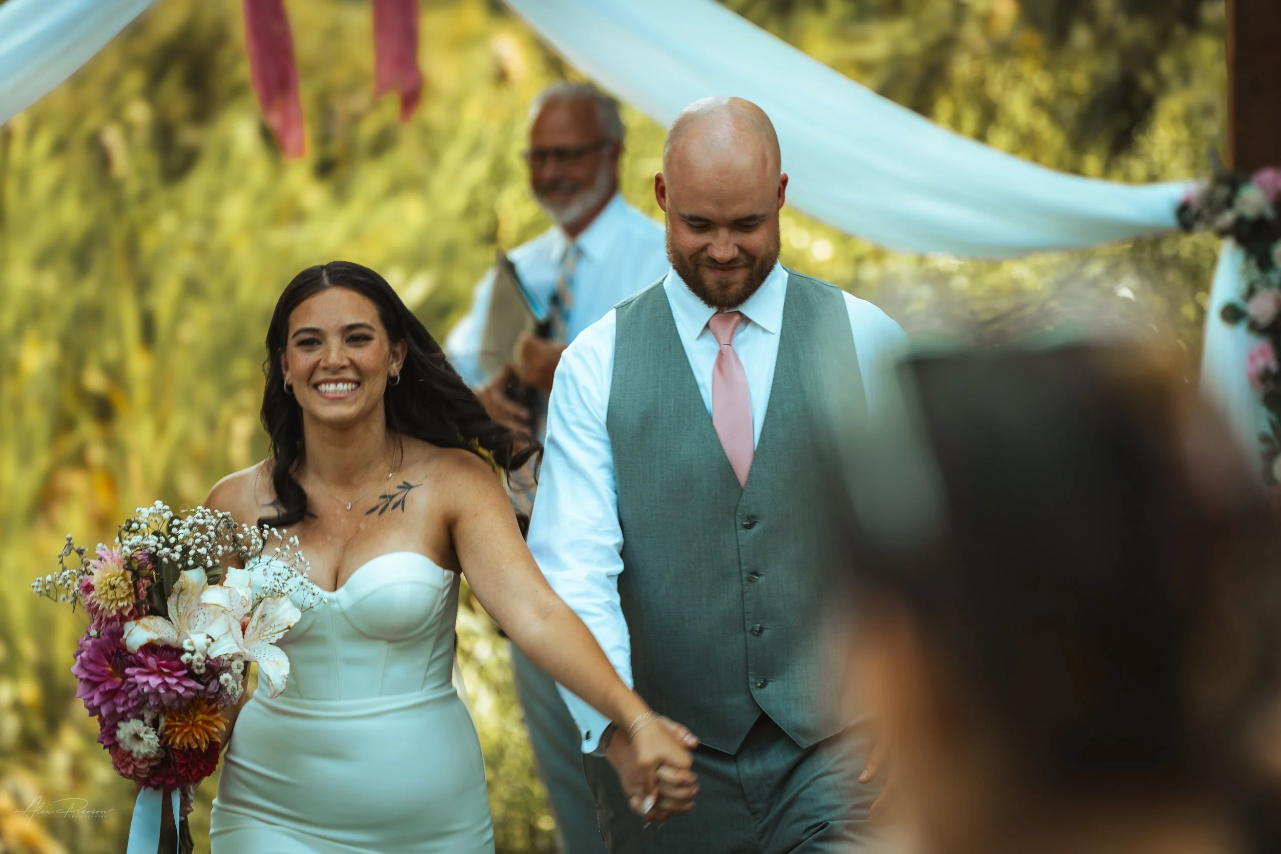bride and groom walking away while holding hands during their wedding in Olympia, WA