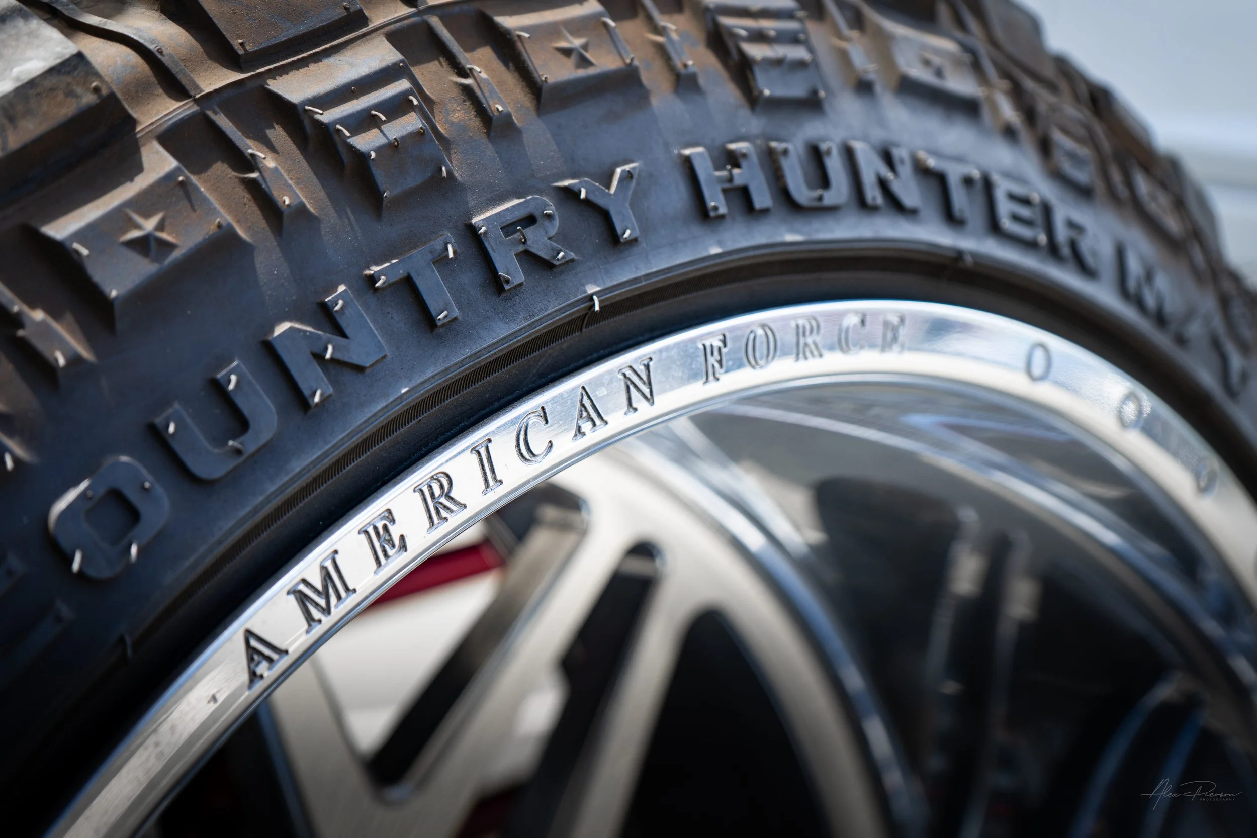 Close-up of premium polished American Force forged wheels wrapped in aggressive Fury Country Hunter M/T off-road tires on a custom show truck.
American Force wheels, Fury MT tires, forged off-road wheels, lifted truck tires.
custom polished American 
