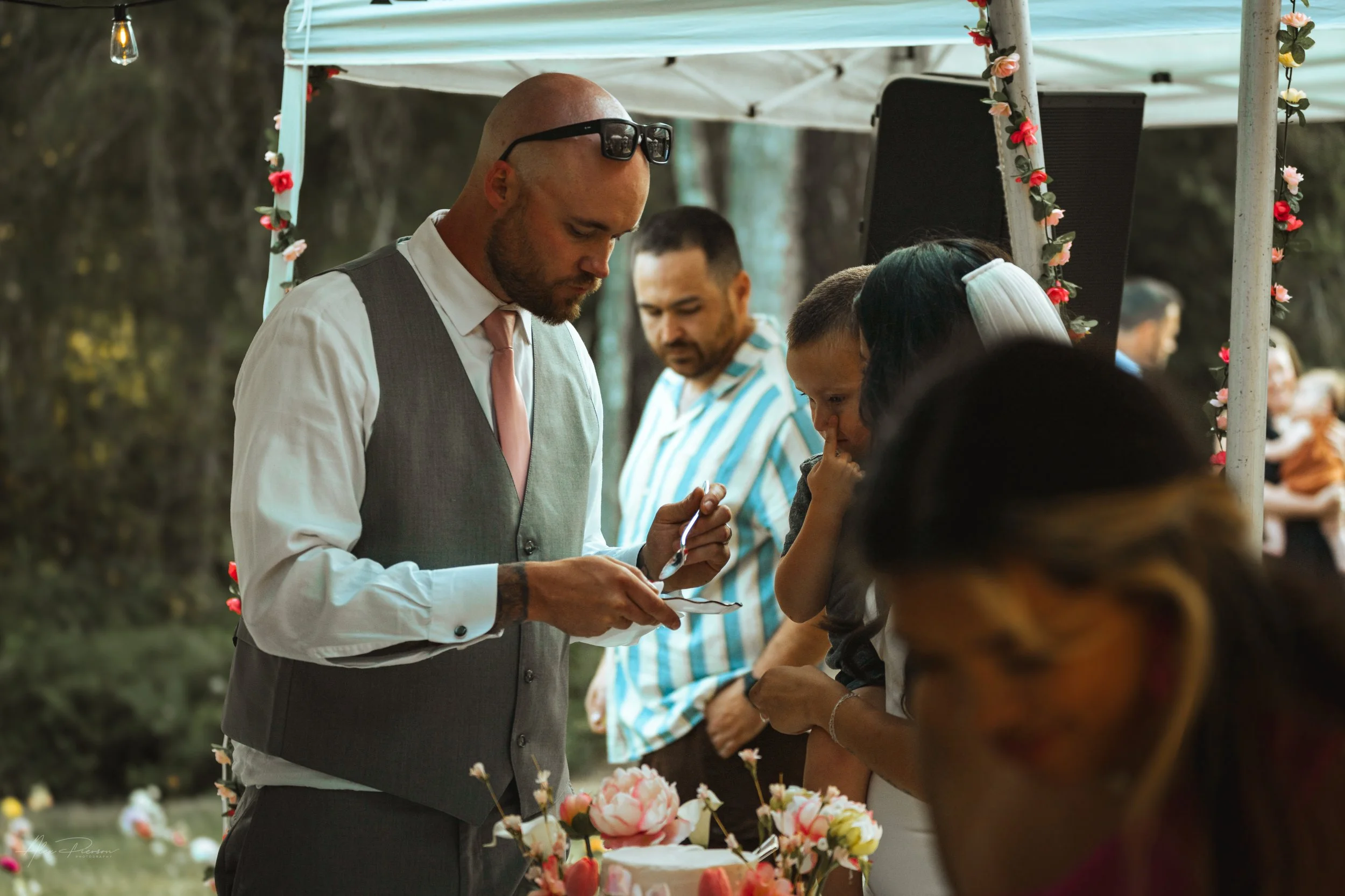 bride and groom cutting and feeding cake to each other during a wedding in Olympia, wa.