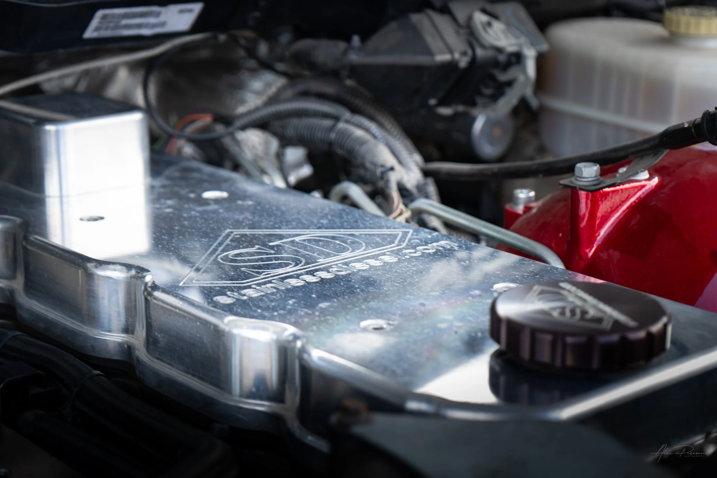 Close-up of a high-quality polished billet aluminum Stainless Diesel valve cover installed on a fully built 6.7L Cummins diesel engine.
Stainless Diesel, billet valve cover, Cummins engine parts, Ram 2500 under hood.
polished billet aluminum Stainles