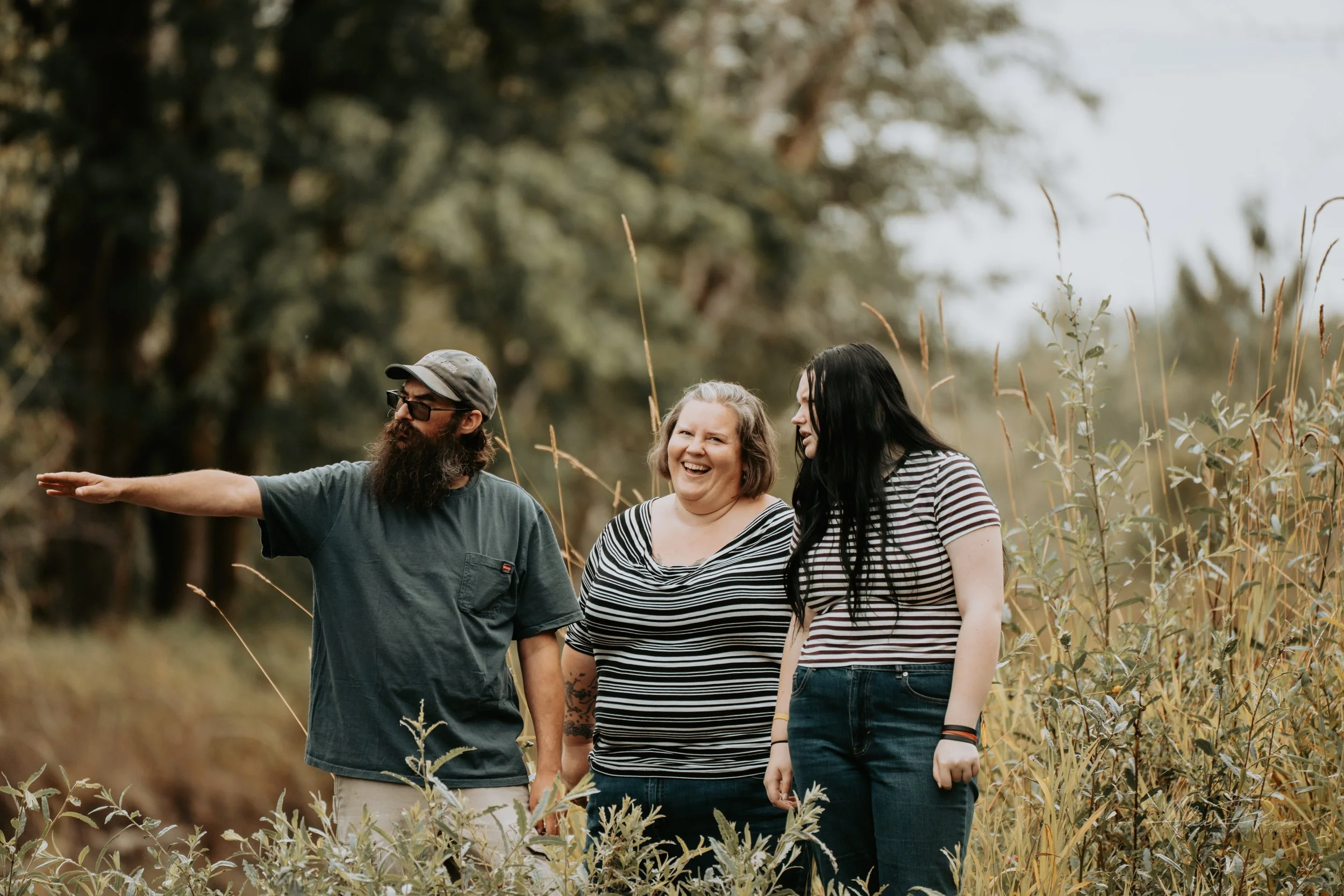 Mother and Daughter and Father posing for the camera during an autumn family photoshoot in their backyard in Montesano, WA- – Pacific Northwest lifestyle family and children's photography.