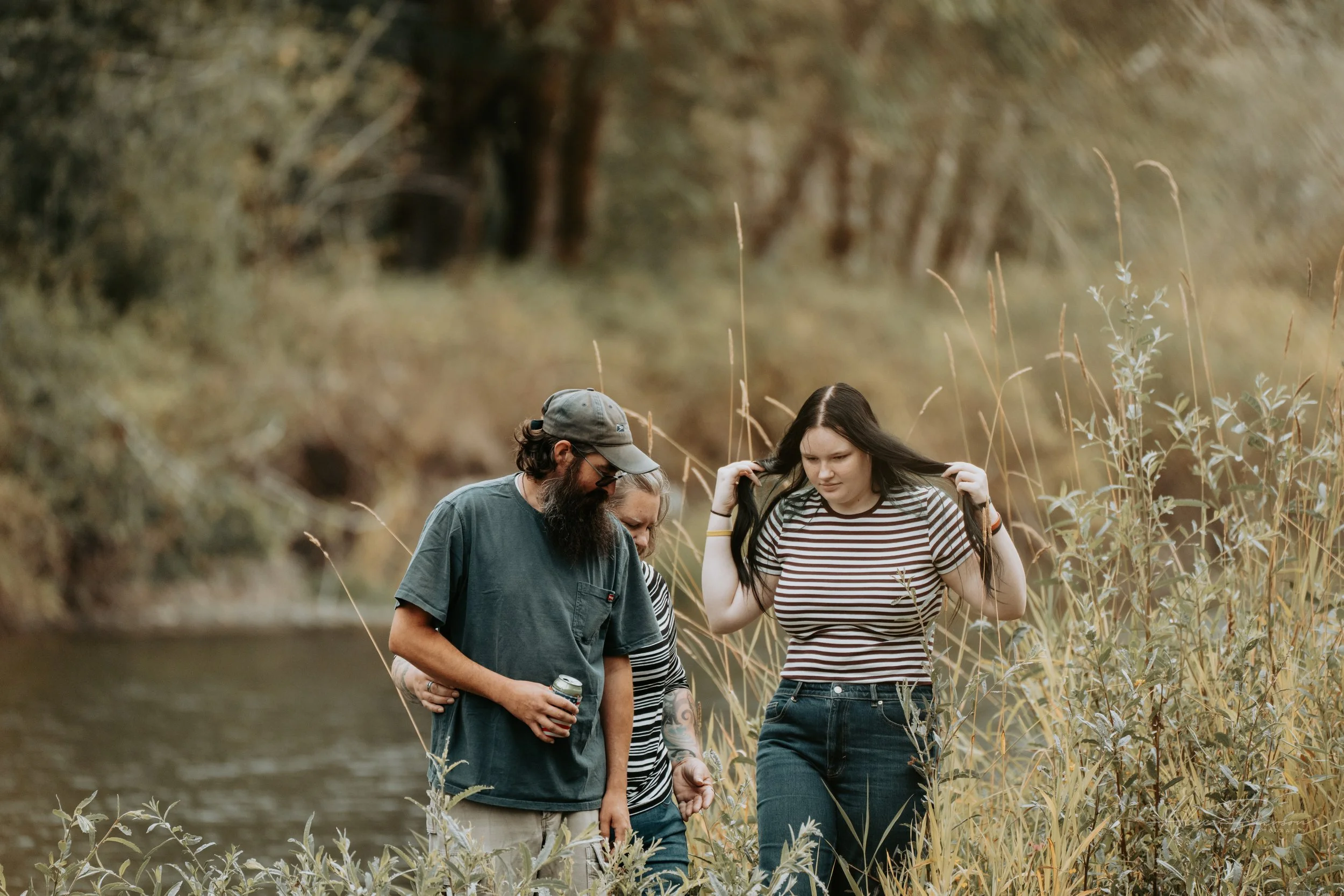 Mother and Daughter and Father posing for the camera during an autumn family photoshoot in their backyard in Montesano, WA- – Pacific Northwest lifestyle family and children's photography.