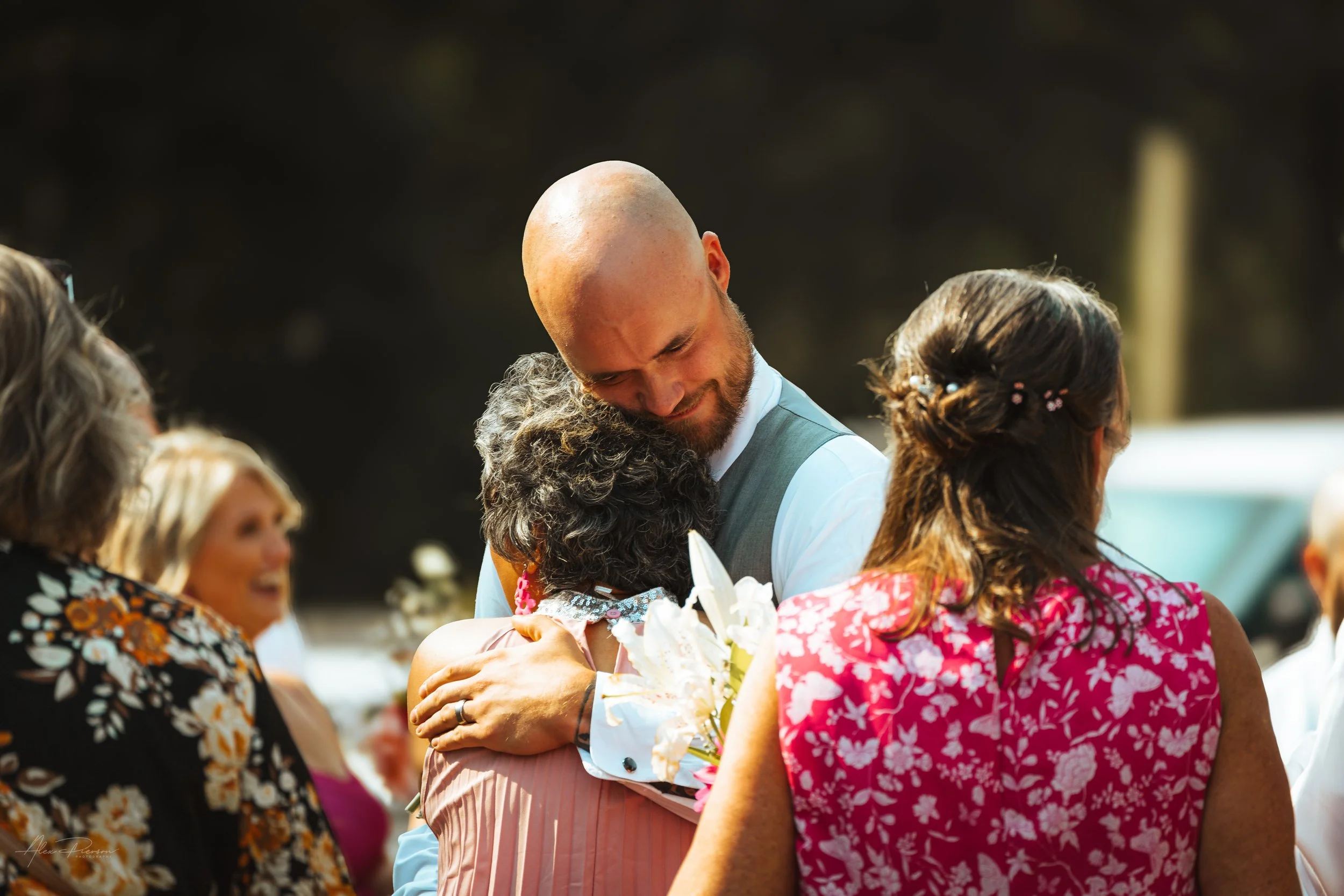 groom and guest hugging during his wedding in Olympia, wa