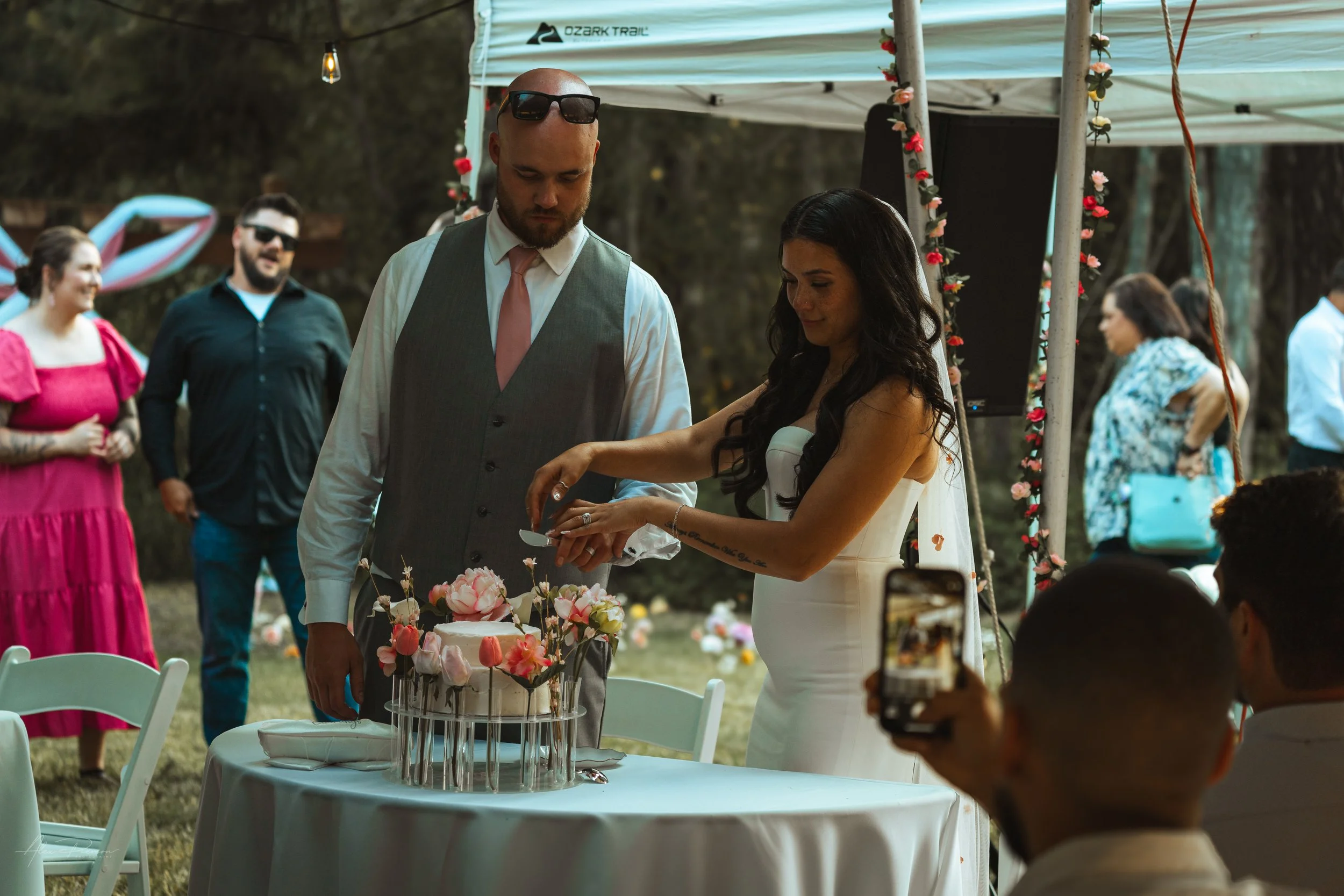 bride and groom cutting and feeding cake to each other during a wedding in Olympia, wa.