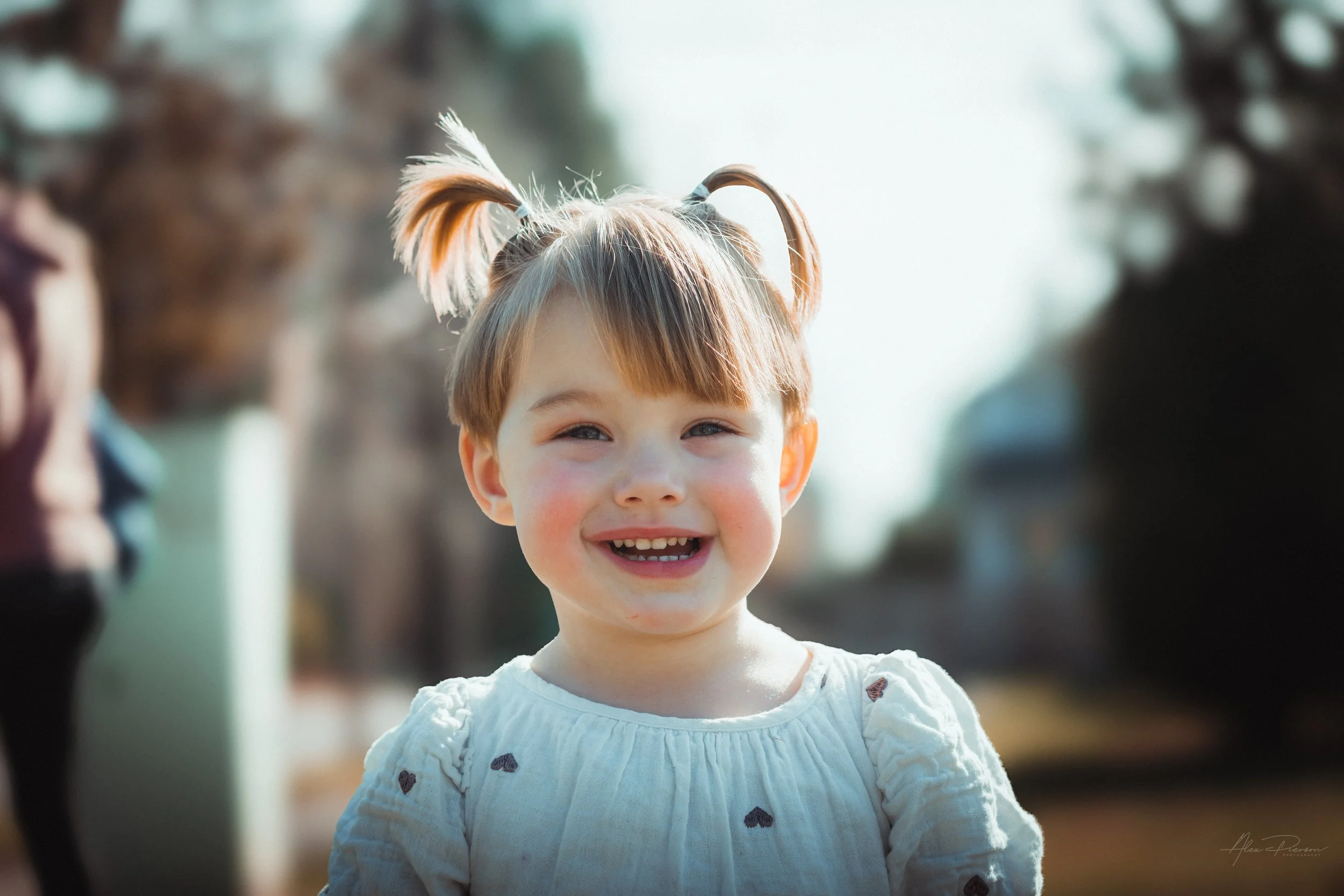 Little girl smiling and walking during a lifestyle shoot in Tumwater, WA– Pacific Northwest lifestyle family and children's photography.