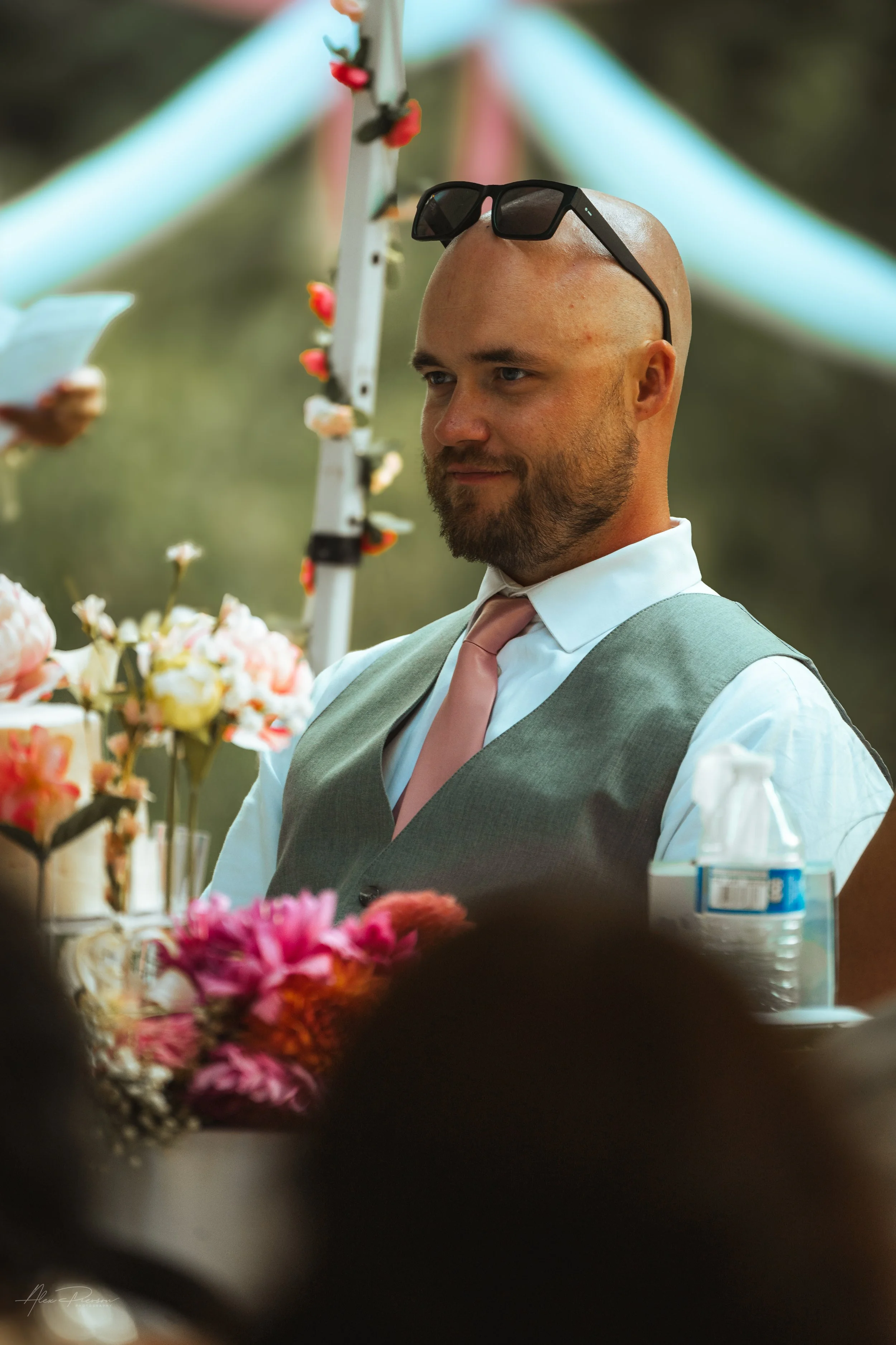 groom sitting in a chair while people give speeches during a wedding in Olympia, wa