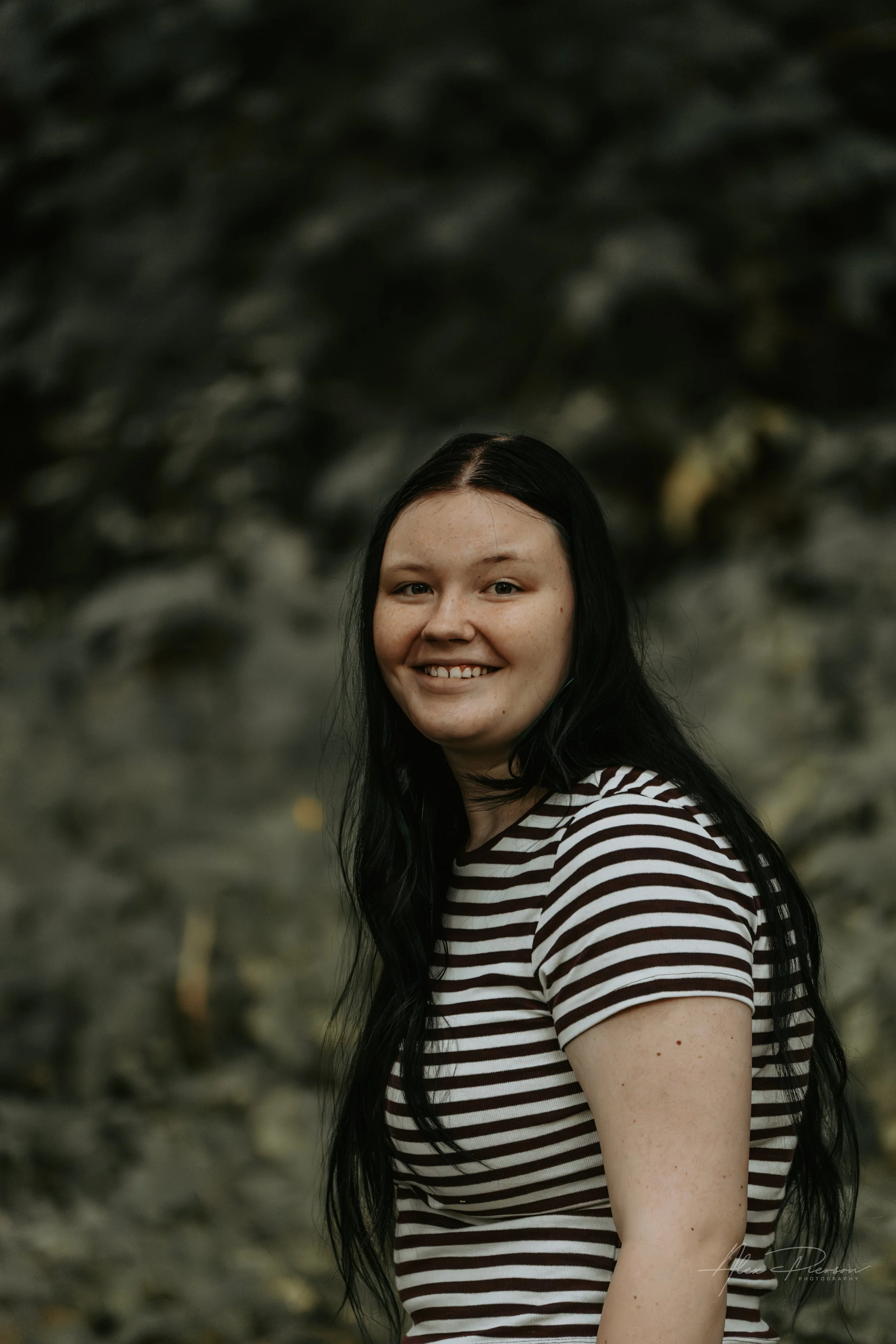 An up close portrait of a young lady wearing a black and white striped shirt during a family photoshoot in Montesano, WA-Pacific Northwest lifestyle family and children's photography.