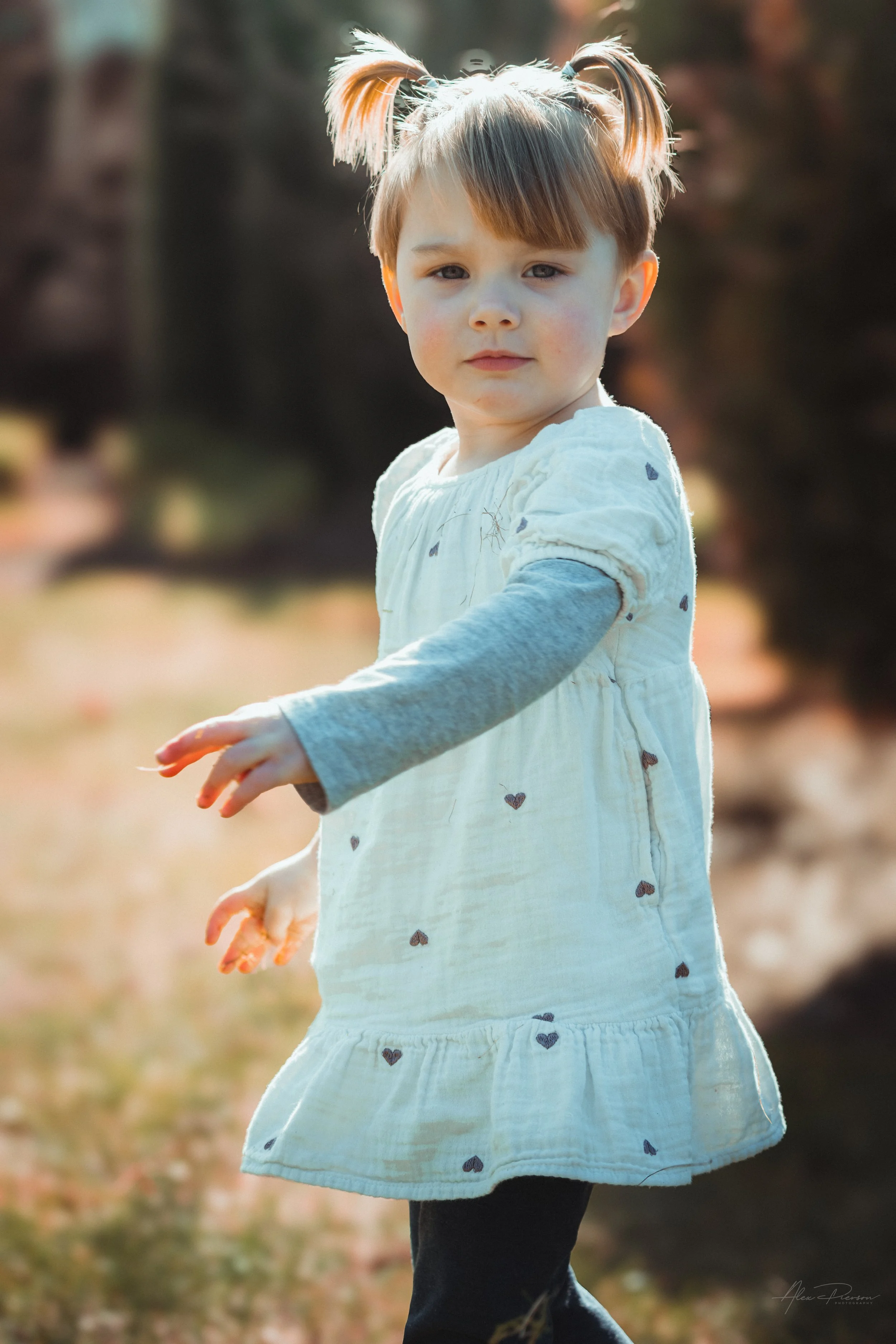 Little girl smiling and walking during a lifestyle shoot in Tumwater, WA– Pacific Northwest lifestyle family and children's photography.