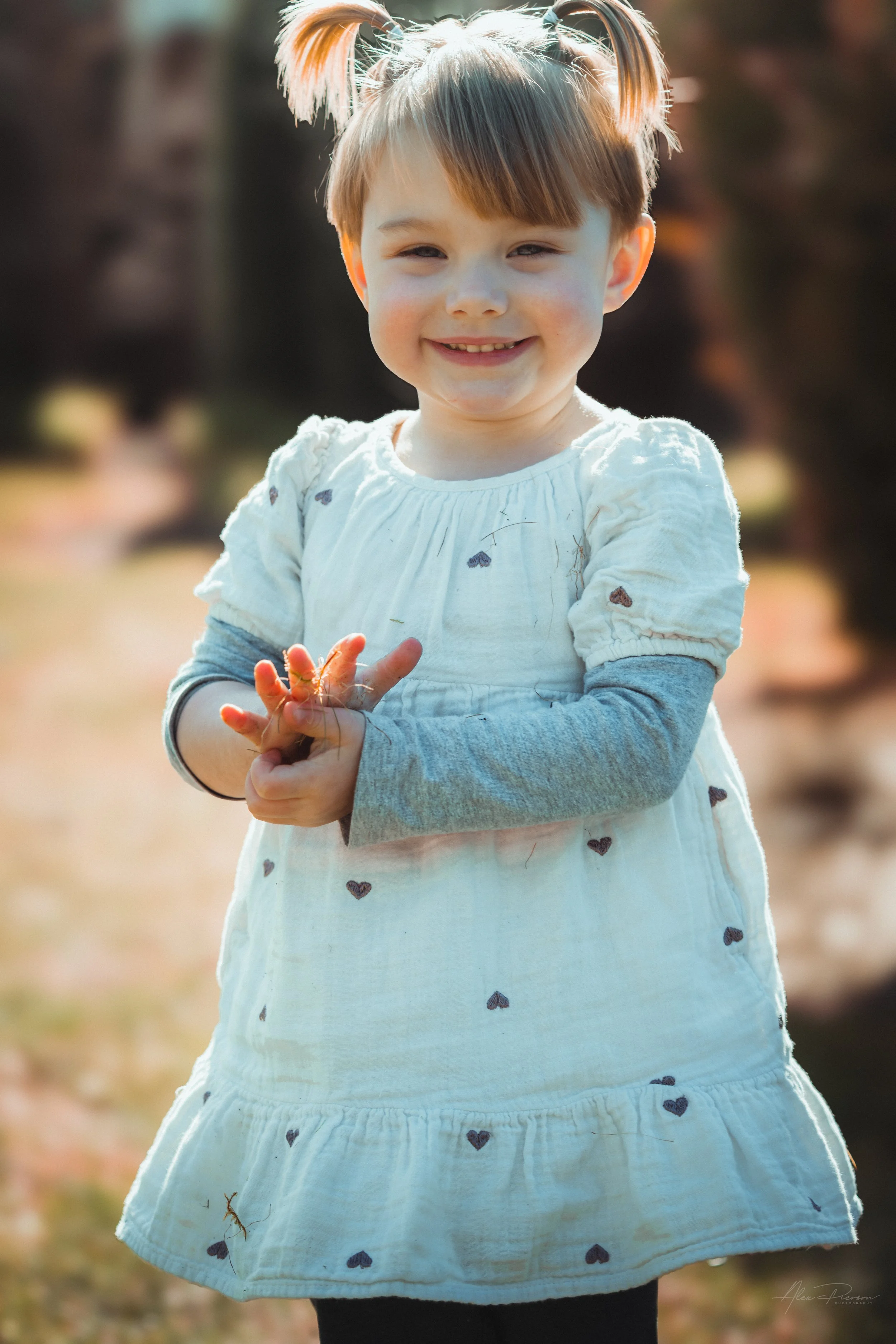Little girl smiling and walking during a lifestyle shoot in Tumwater, WA– Pacific Northwest lifestyle family and children's photography.