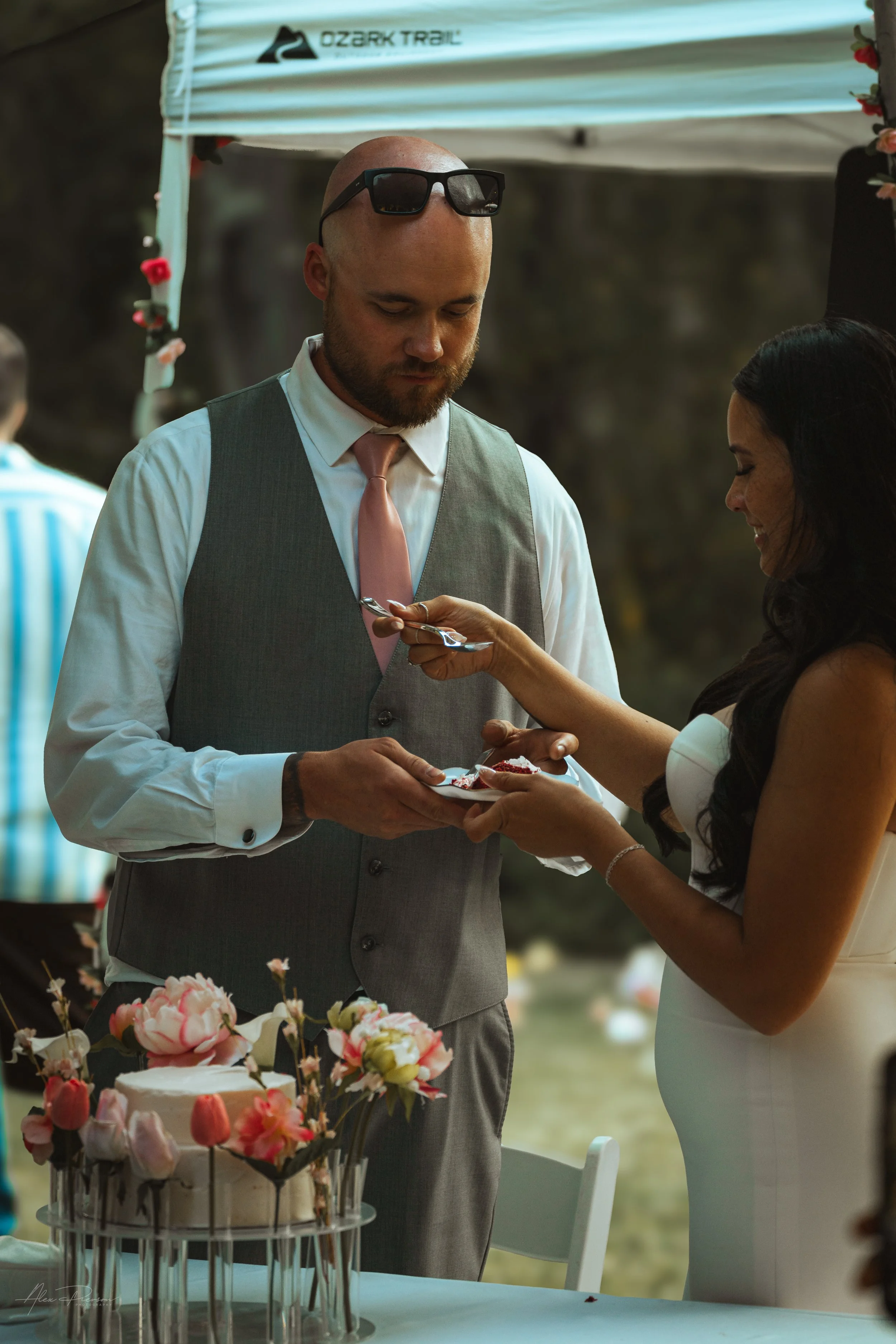 bride and groom cutting and feeding cake to each other during a wedding in Olympia, wa.
