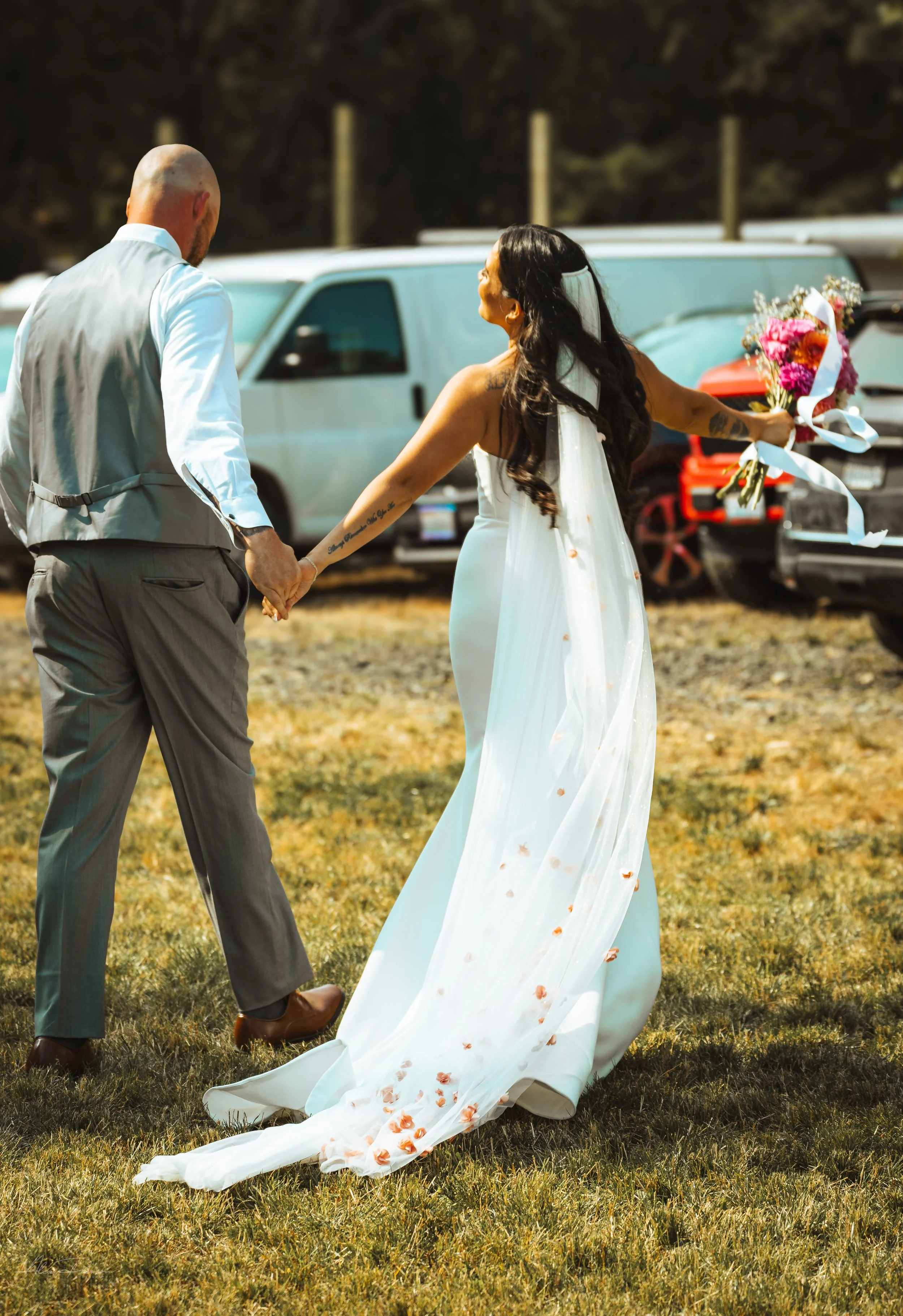 bride and groom walking away while holding hands during their wedding in Olympia, WA