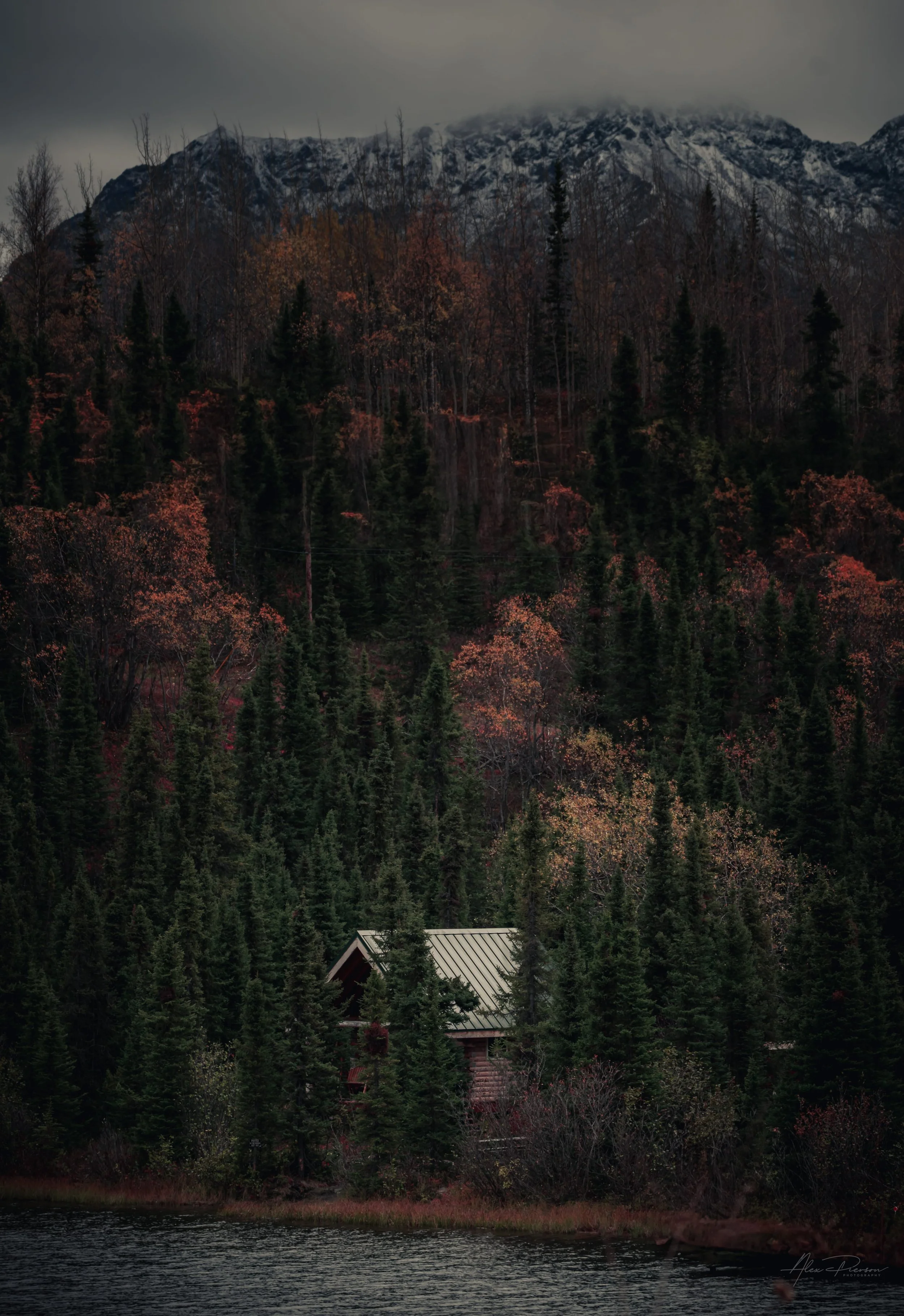 secluded-cabin-lake-alaska-mountain-backdrop.jpg