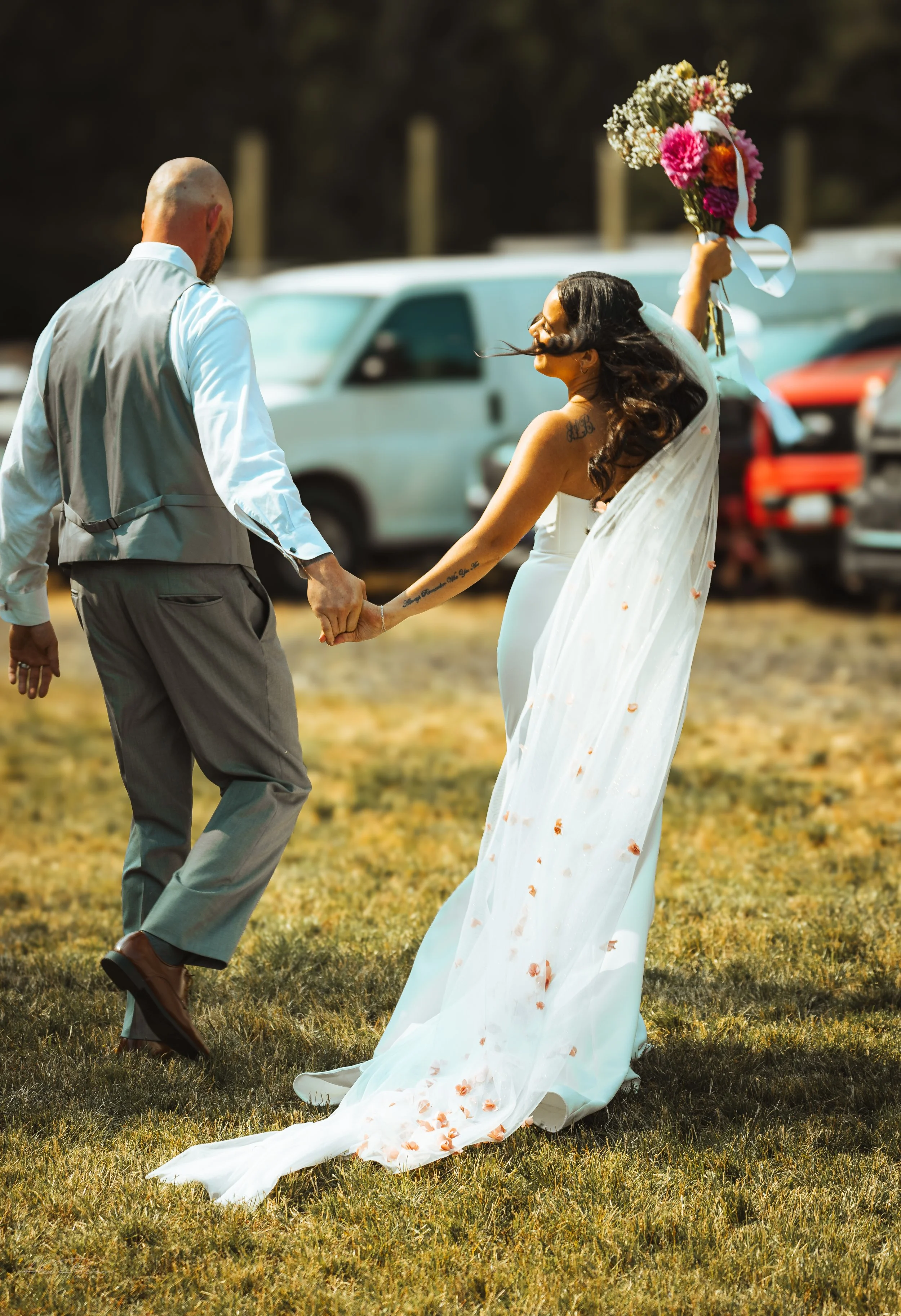 bride and groom walking away while holding hands during their wedding in Olympia, WA