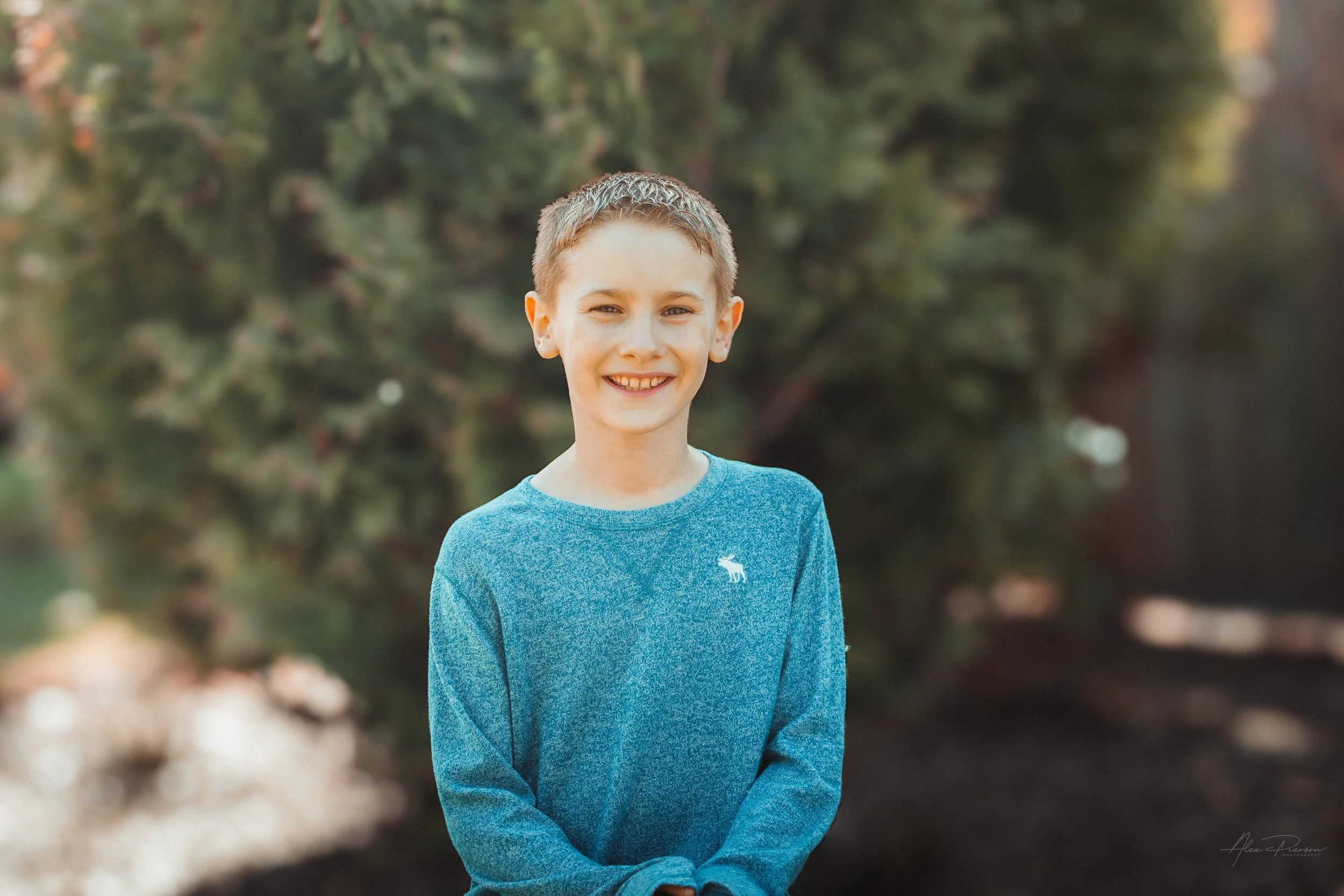Warm natural light portrait of a young boy smiling outdoors in Tumwater, WA – Pacific Northwest lifestyle family and children's photography.
